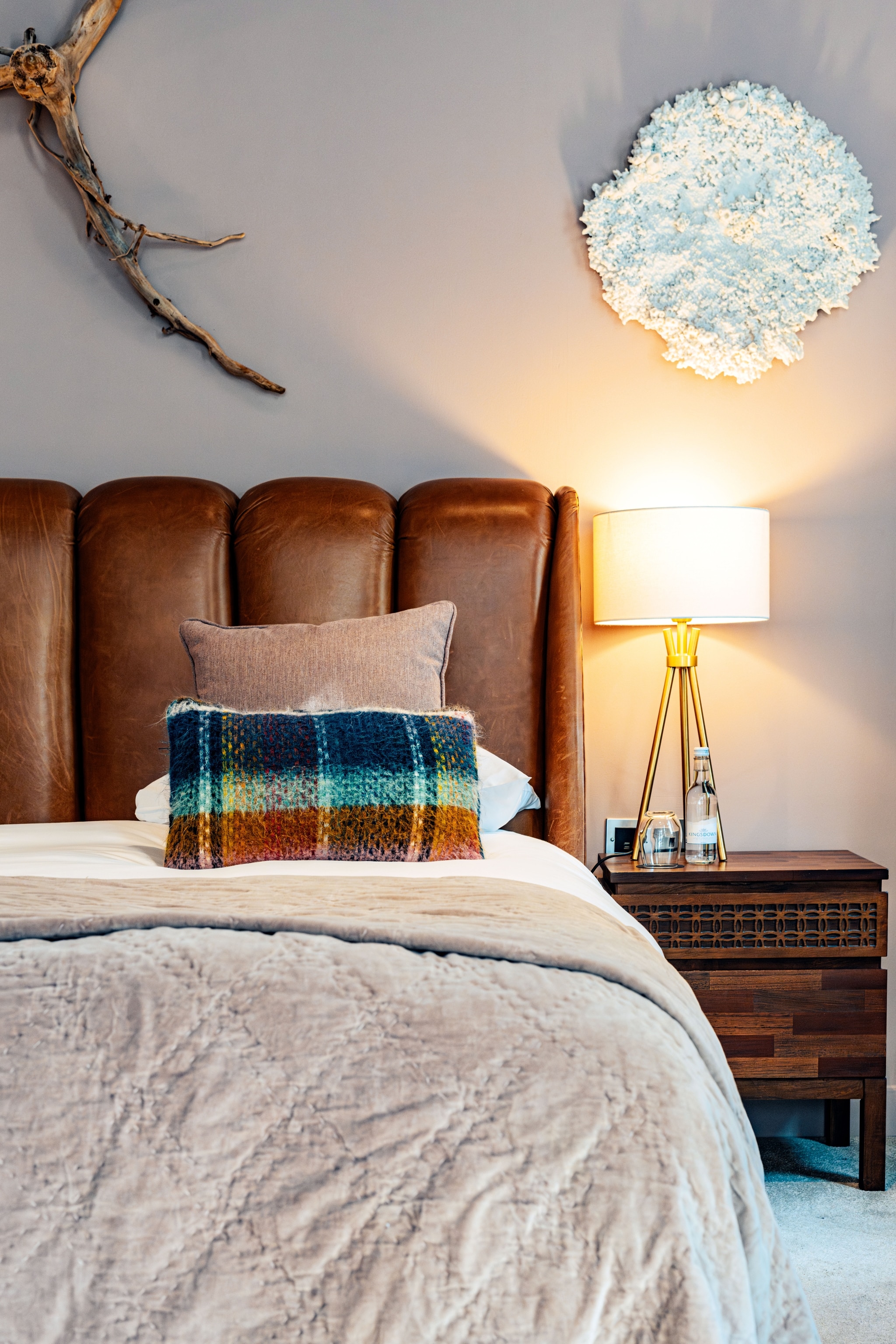 interior of hotel room, feauting pillows, beading and leather headboard