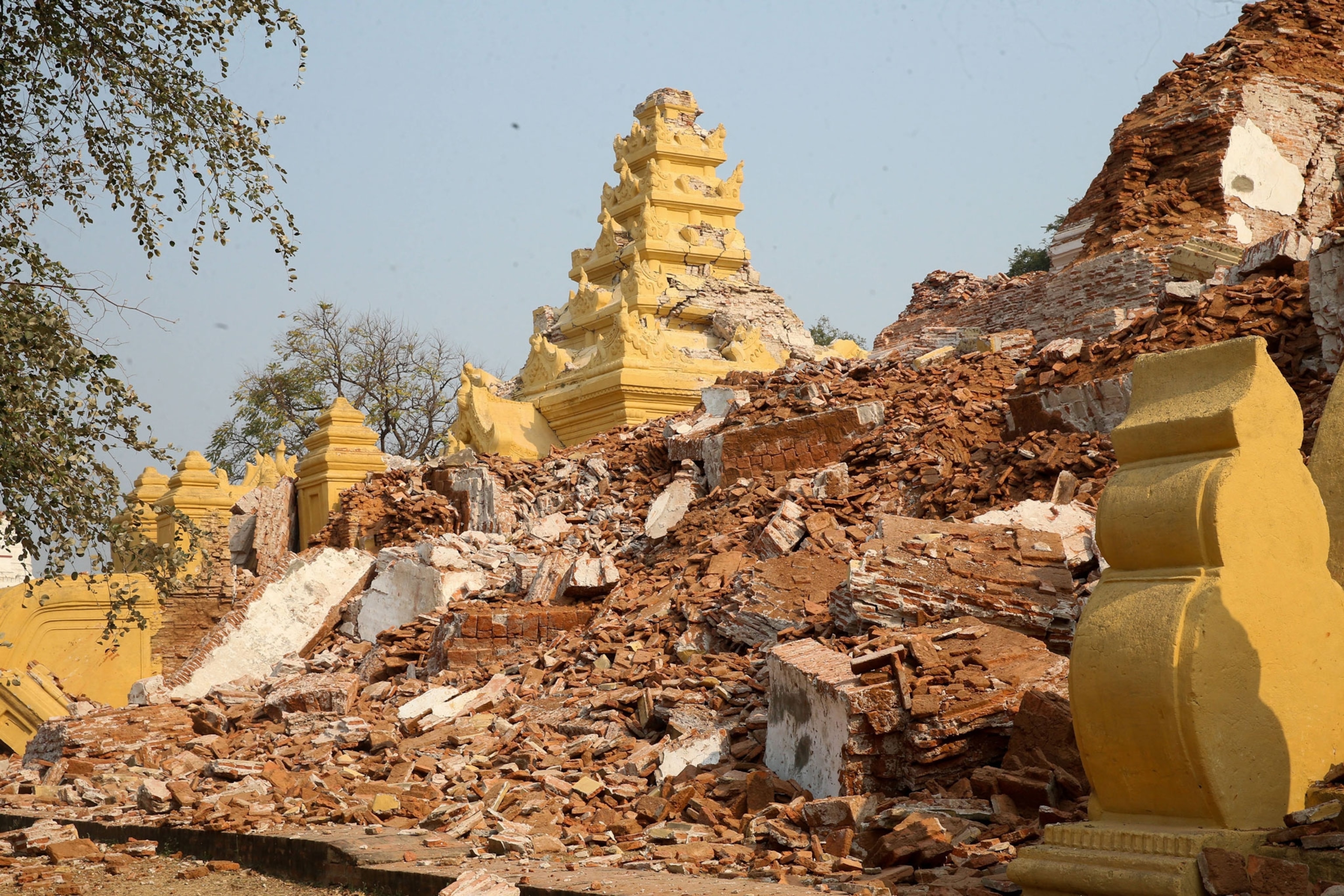 crumbled and flattened gold and brick Buddhist temple