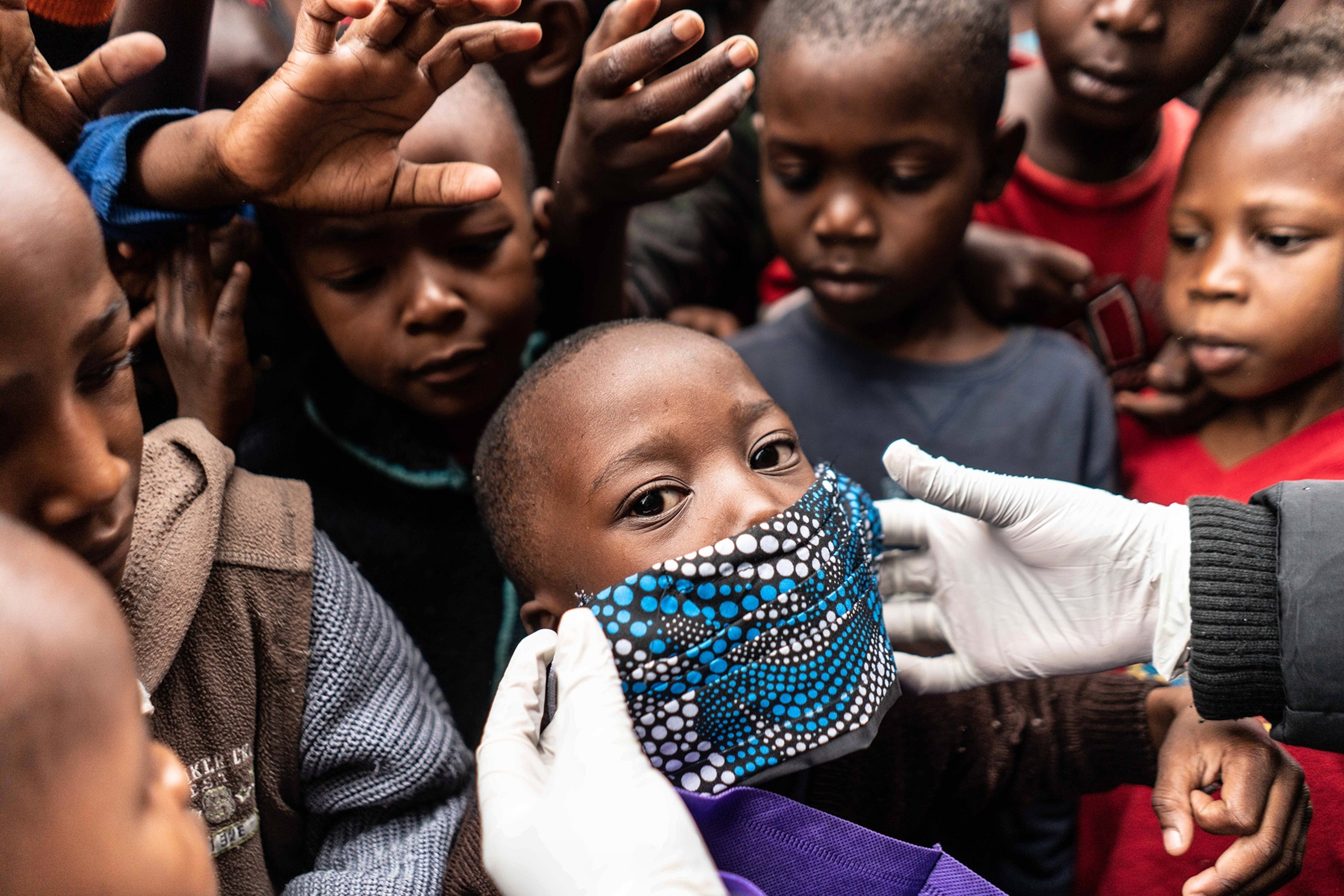 a colorful mask placed on the face of a child