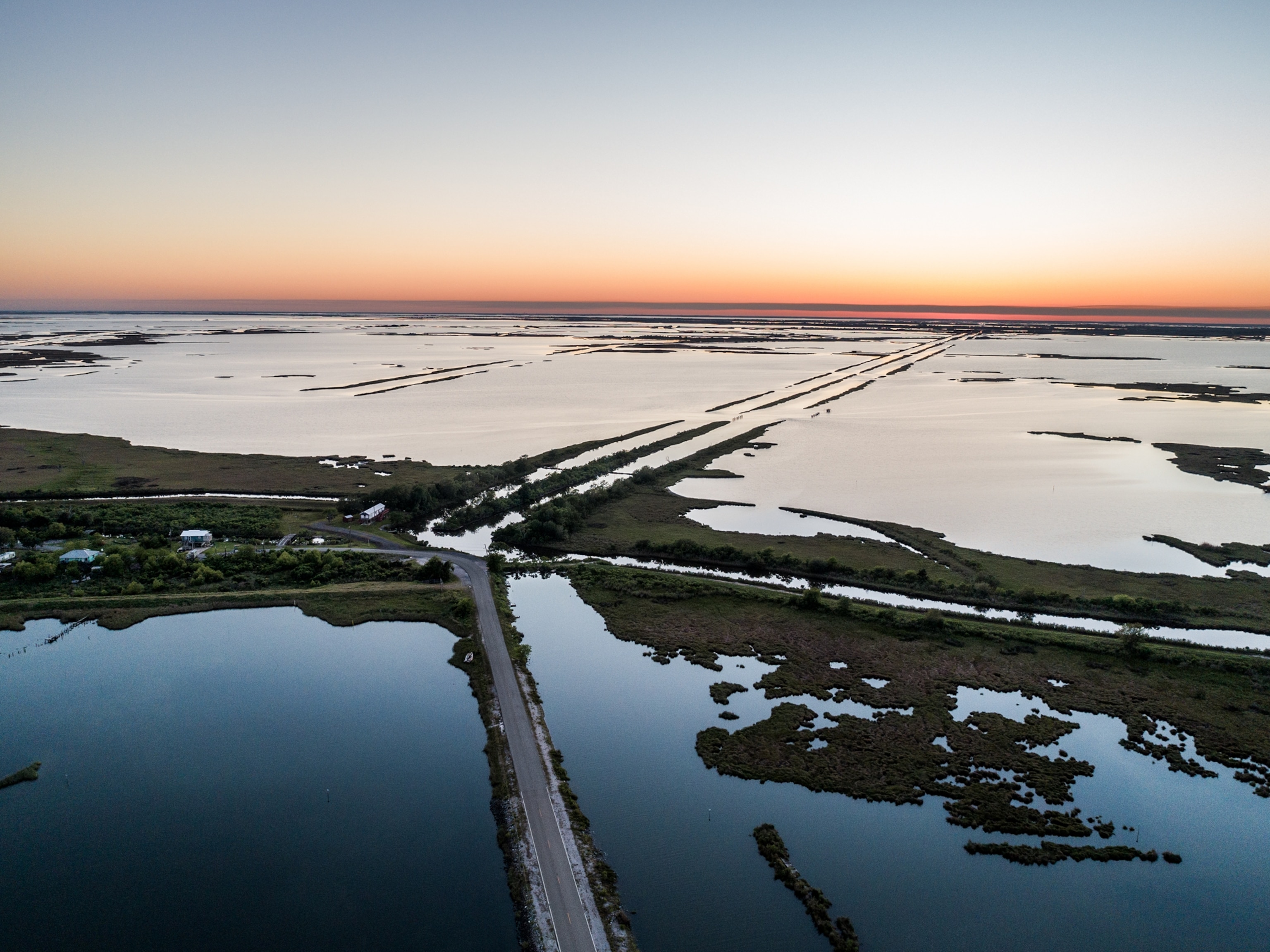 aerial of road though the flooded land.