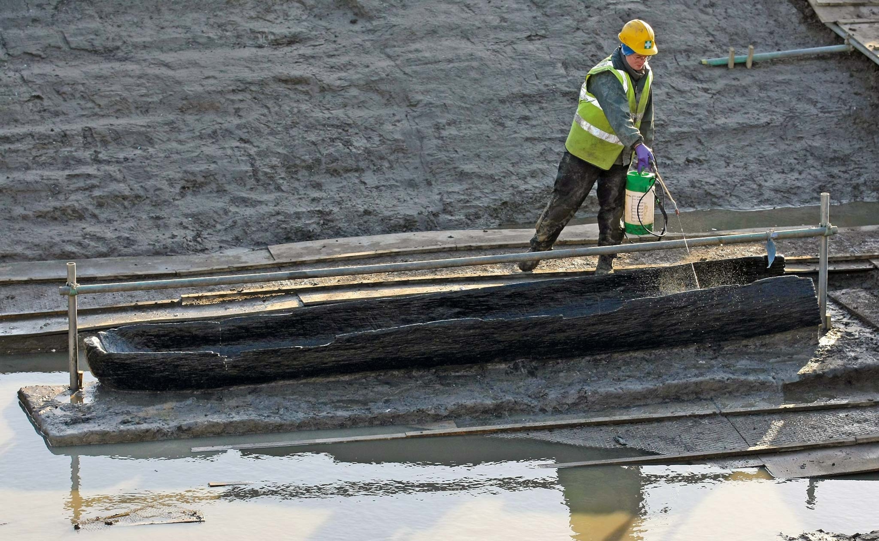 A restorer works on one of the Bronze Age log boats found near Must Farm
