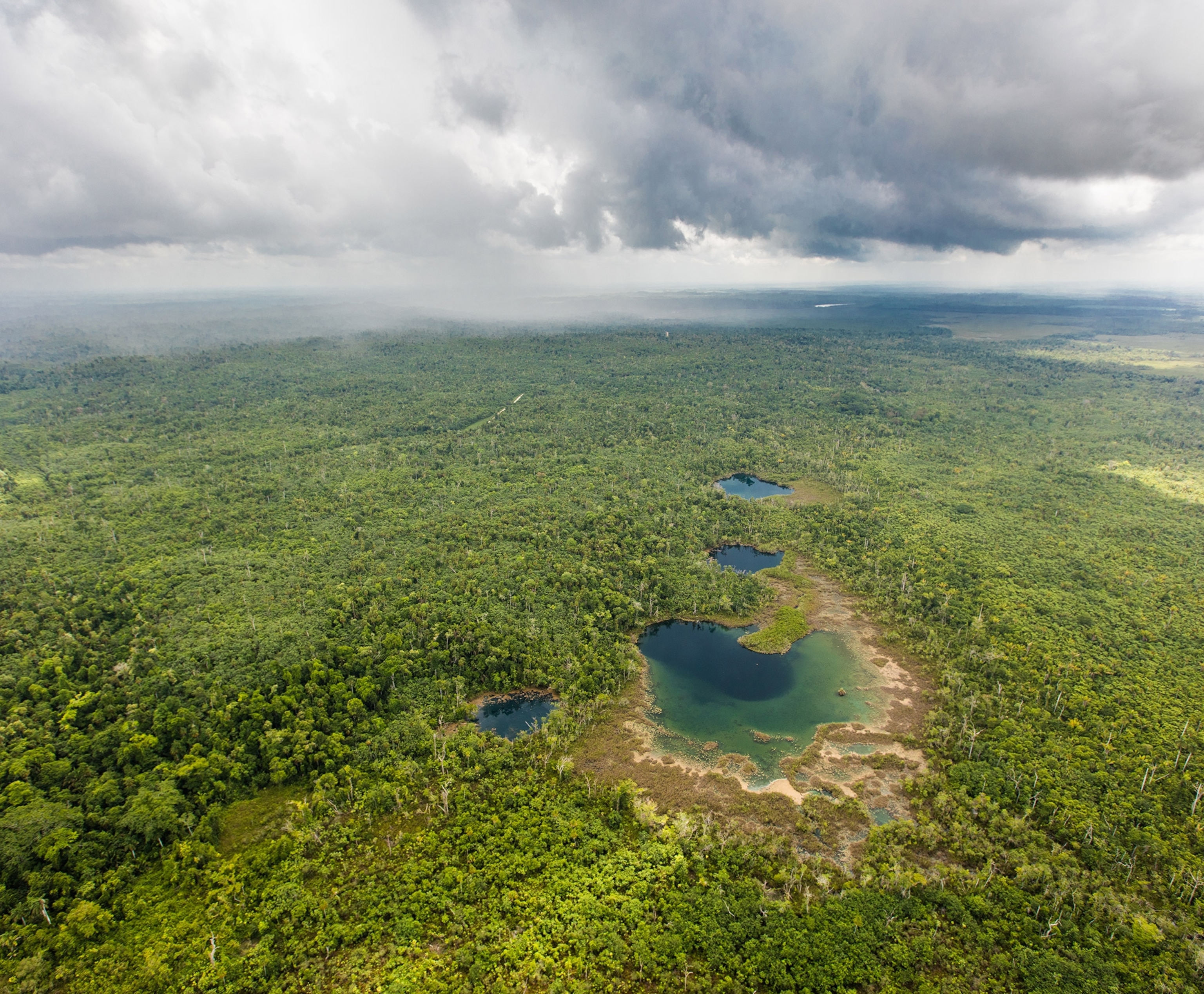 an aerial view of the cara blanca pools in the Belize Maya Forest