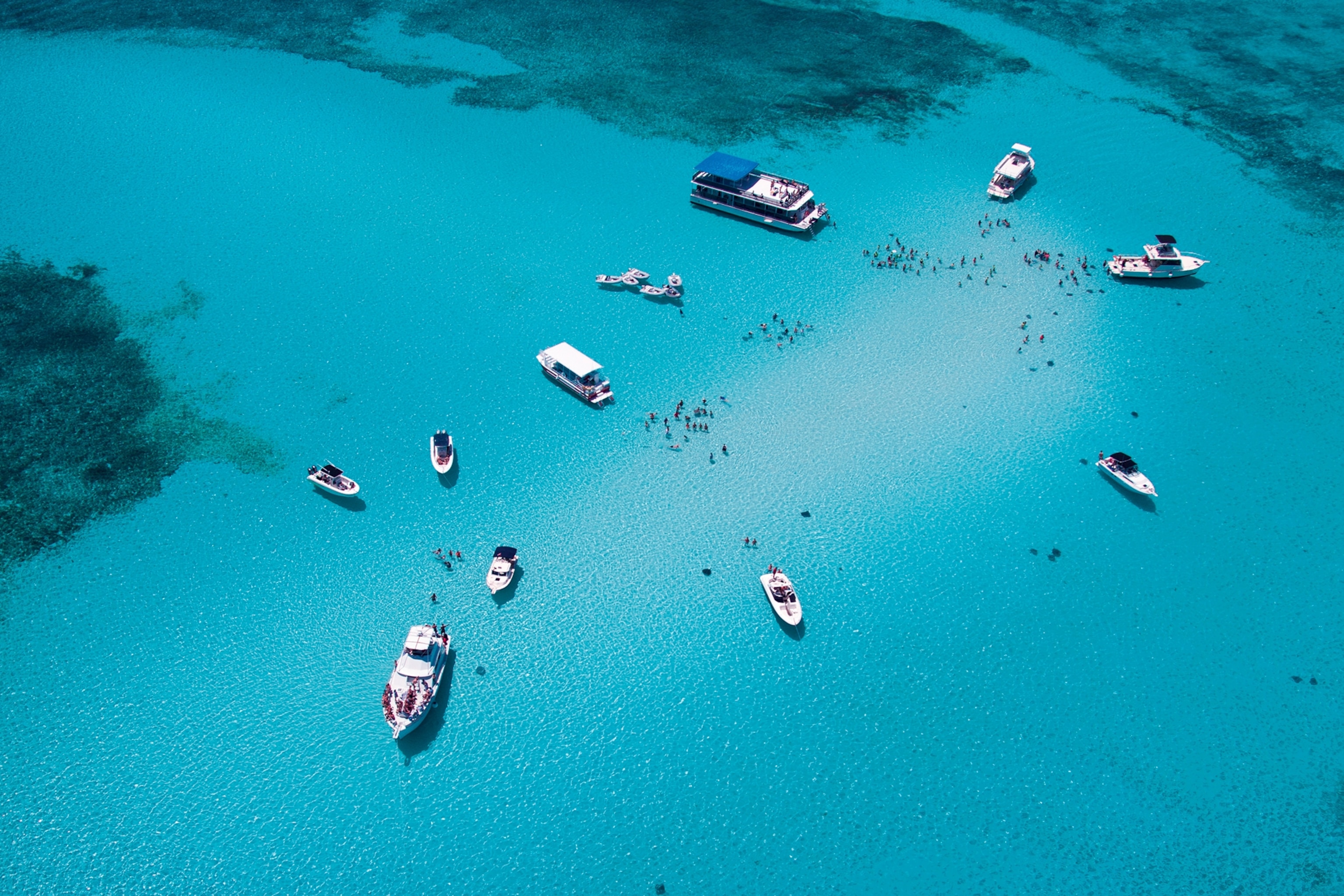 an aerial view of boats on the water