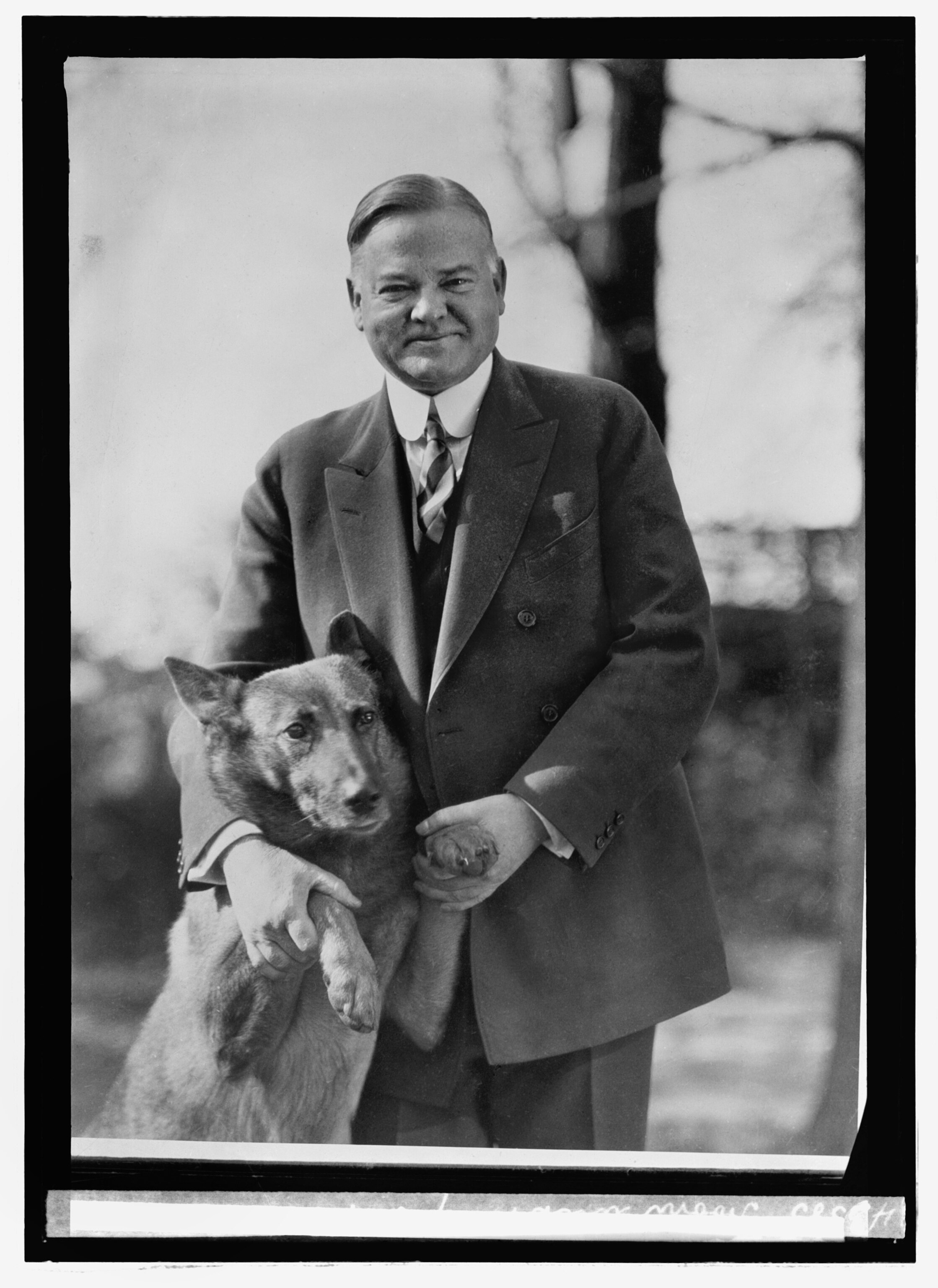 Herbert Hoover and a dog.