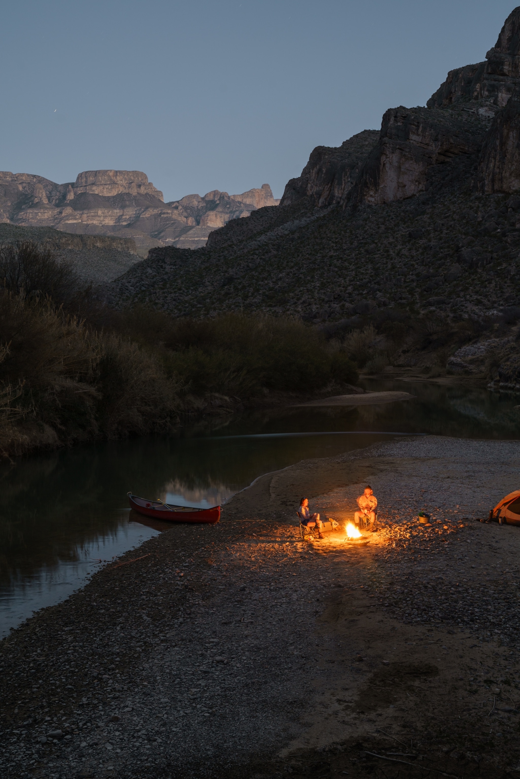 Picture of around campfire next to the river.