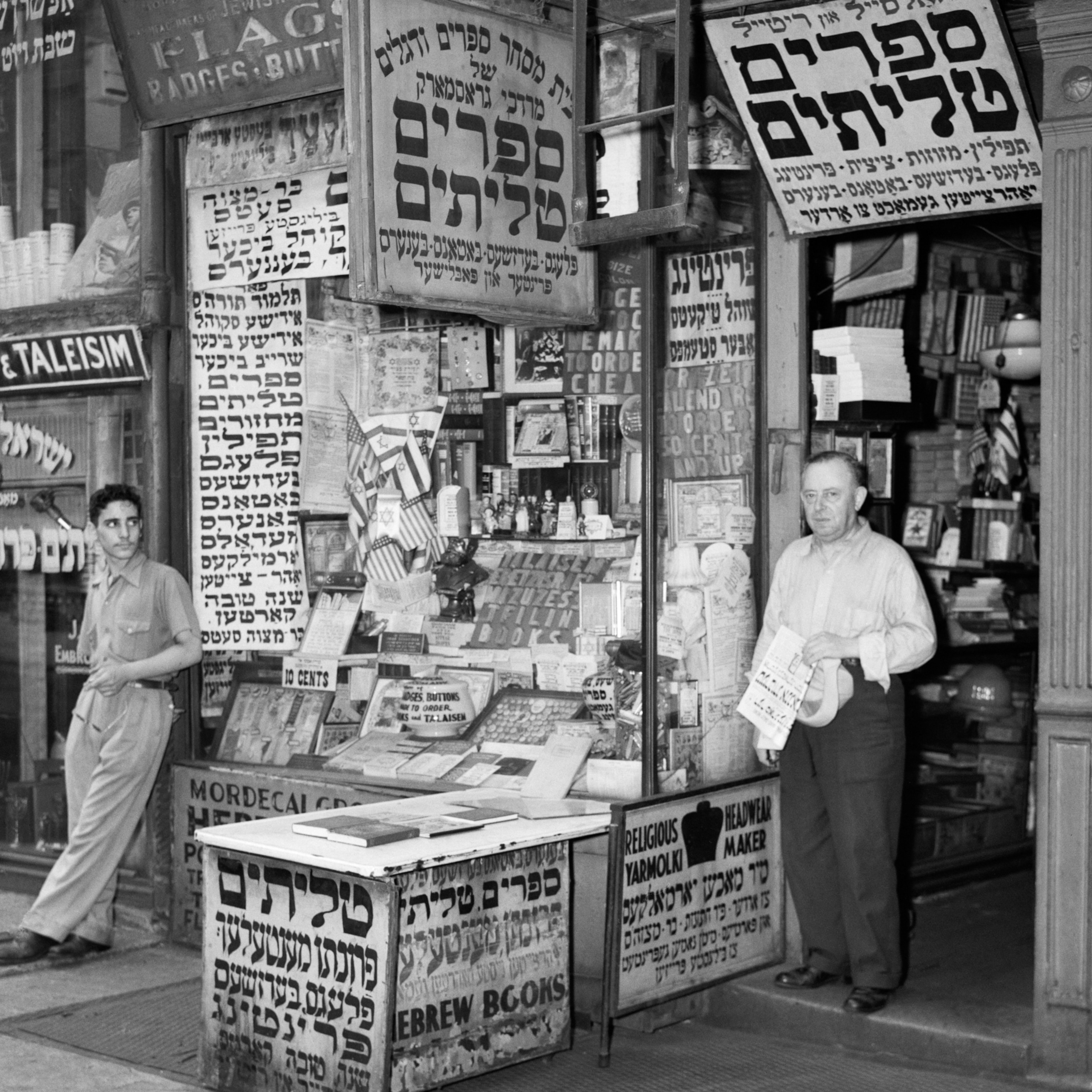 A shop in Manhattan's lower east side is seen covered with signs written in the Yiddish Hebrew alphabet in the 1940s.