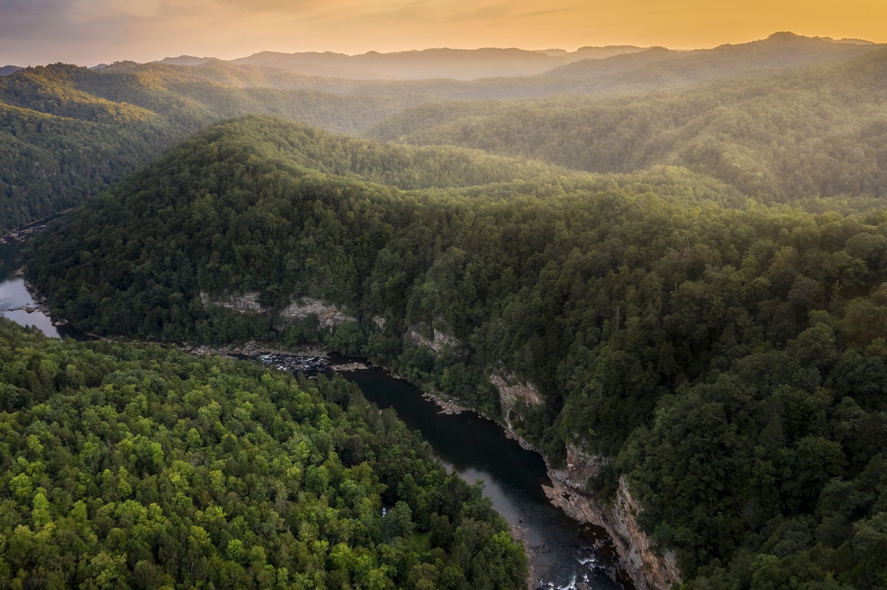 Aerial of the winding Lower Gauley River through the forest in West Virginia.