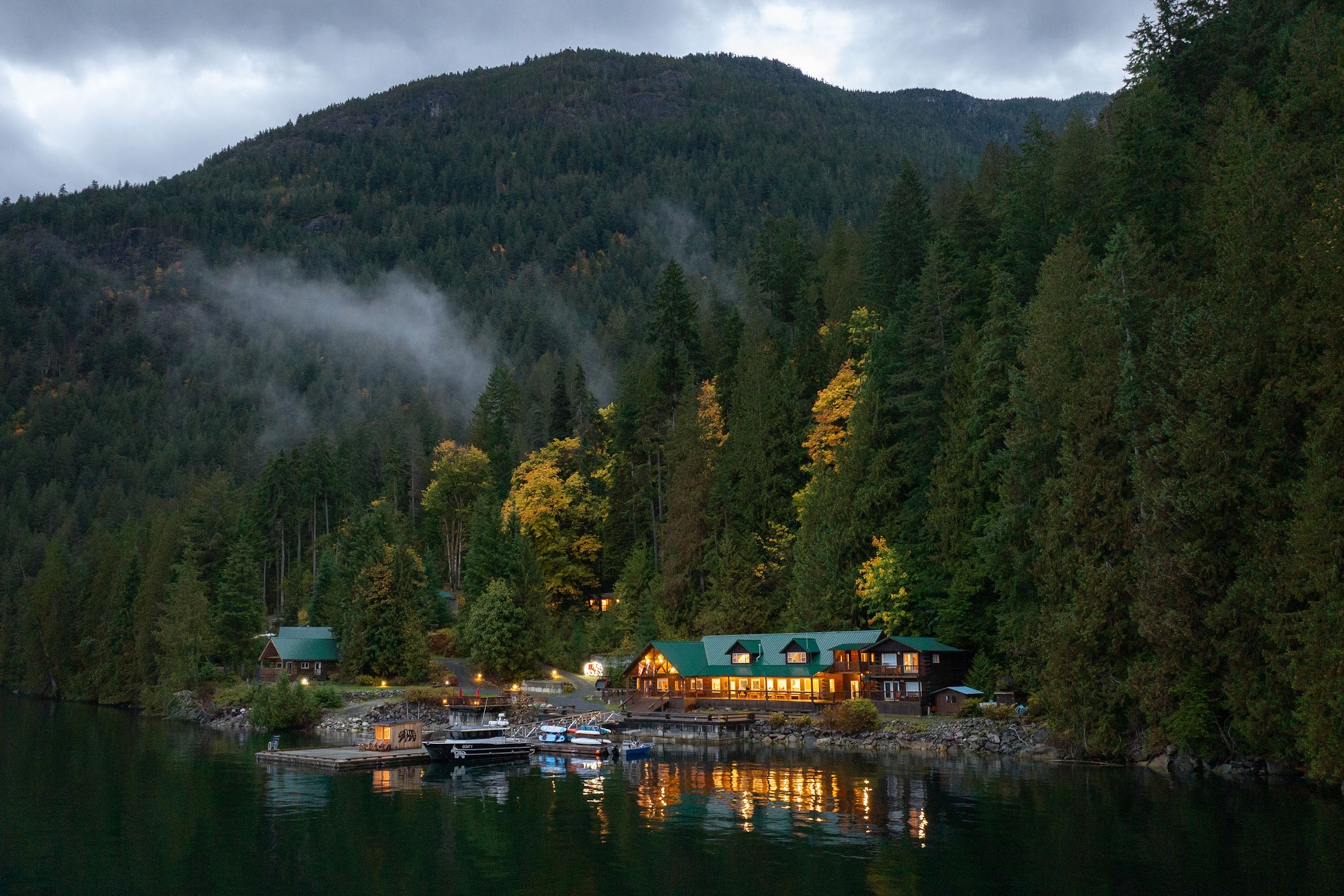 Fall colours surround the cedar timber lodge at Klahoose Wilderness Resort, a sustainable off-grid oceanfront resort in Desolation Sound, British Columbia, Klahoose First Nation Territory