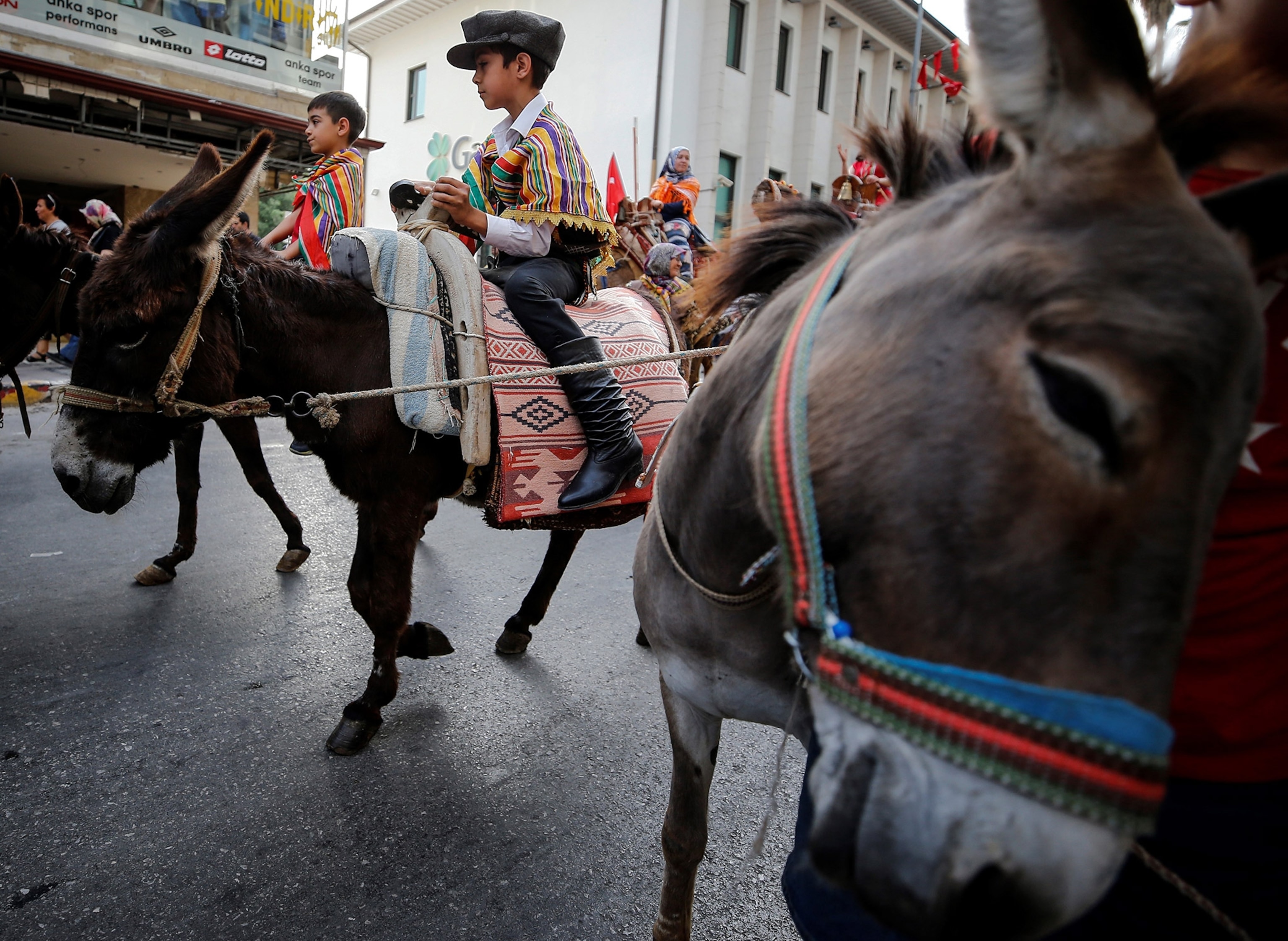 Children ride donkeys to participate in the 4th International Antalya Yoruk Festival
