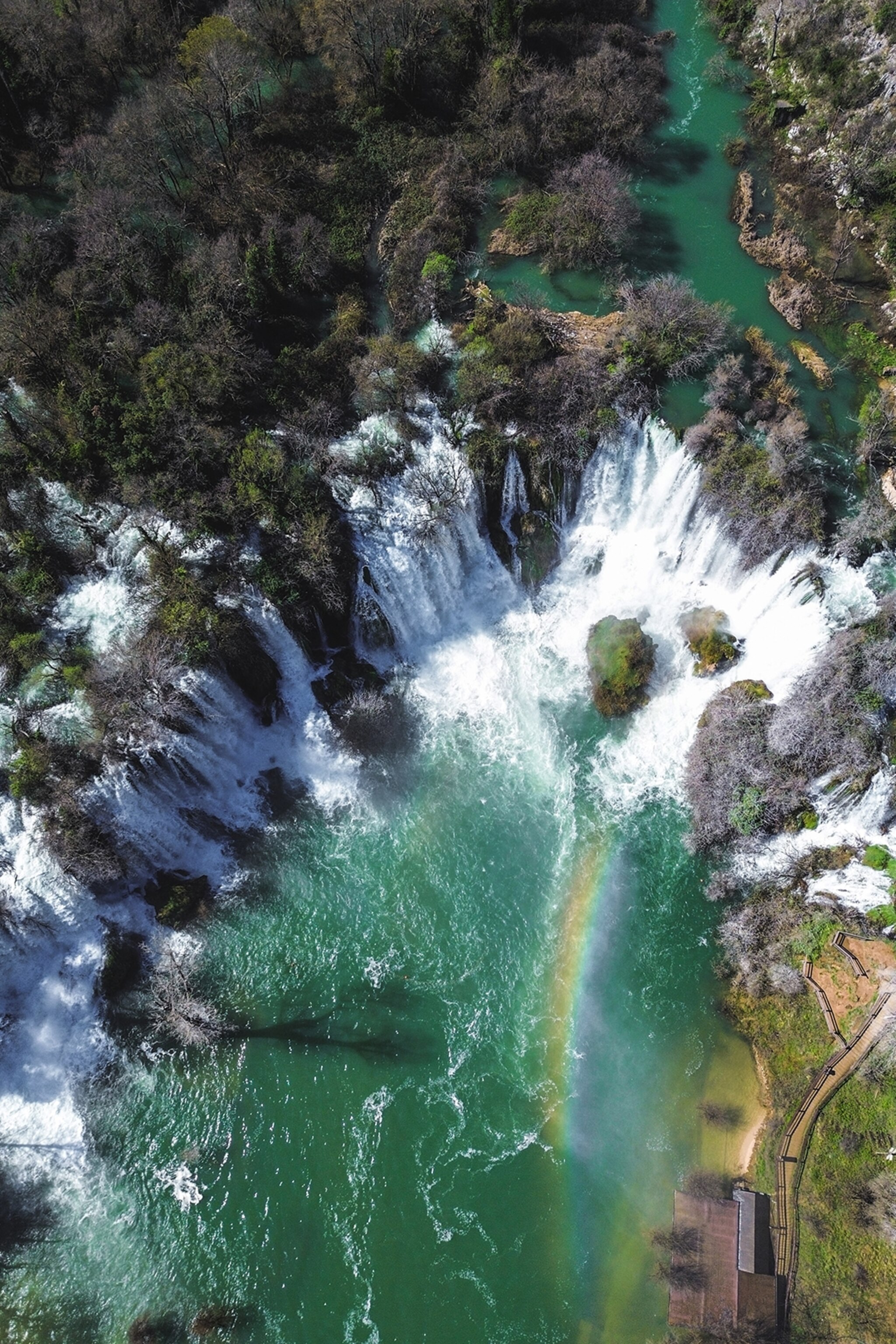 Birds eye view of a waterfall interspersed with vegetation