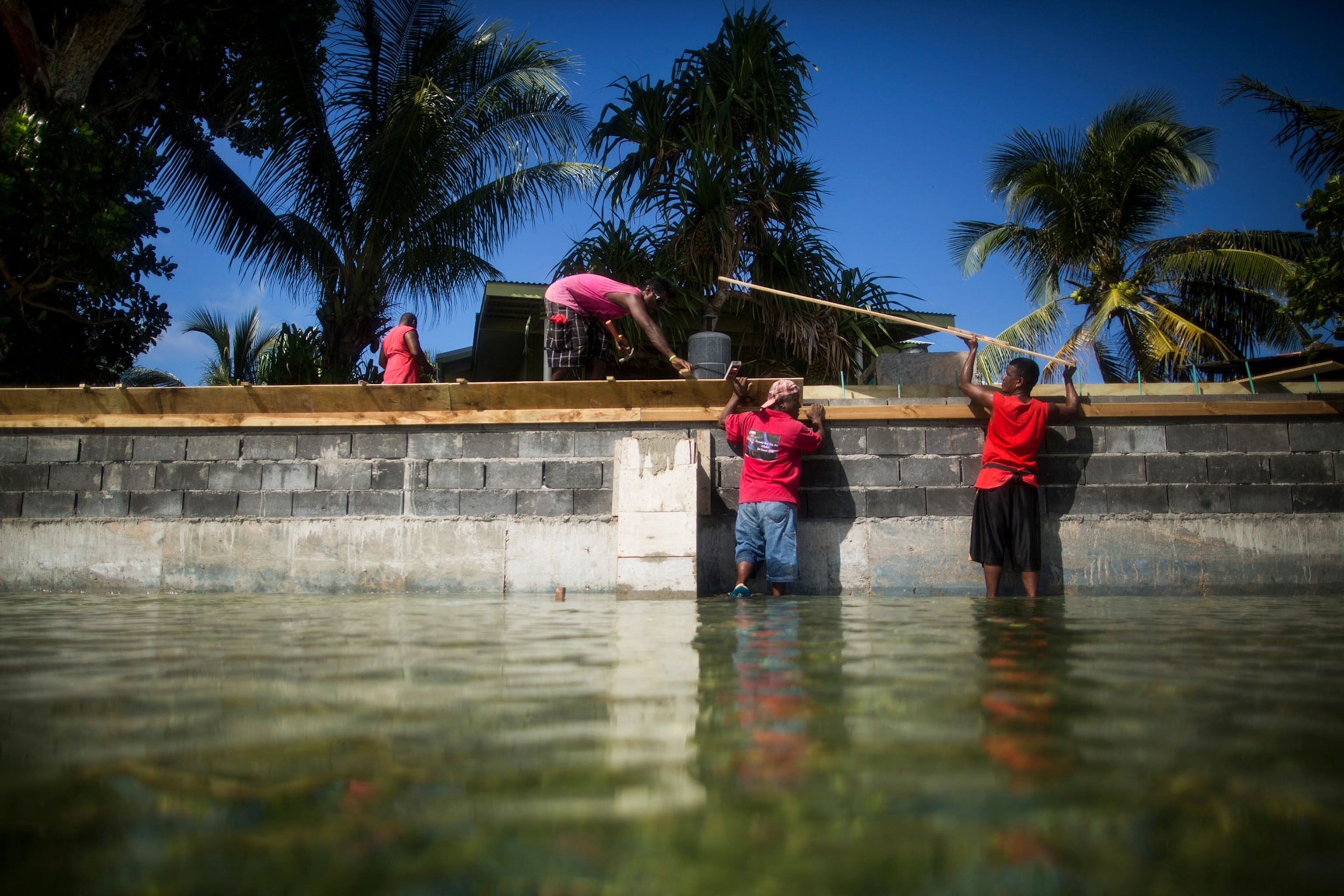 people building a sea wall