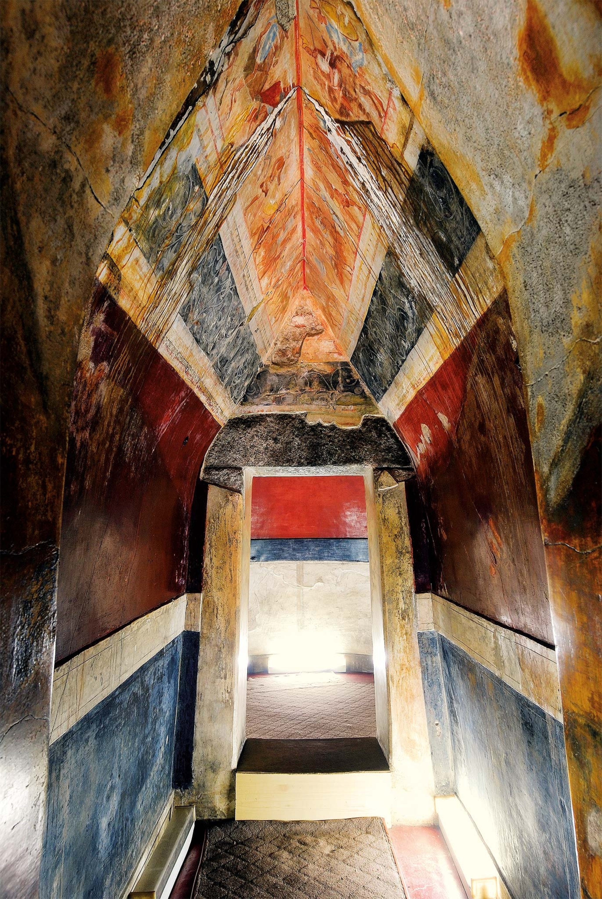 Passageway of the Thracian Tomb of Kazanlak, looking into the burial chamber. Above the colored inlay panels is a frieze in which scenes of cavalry and infantry face one another.