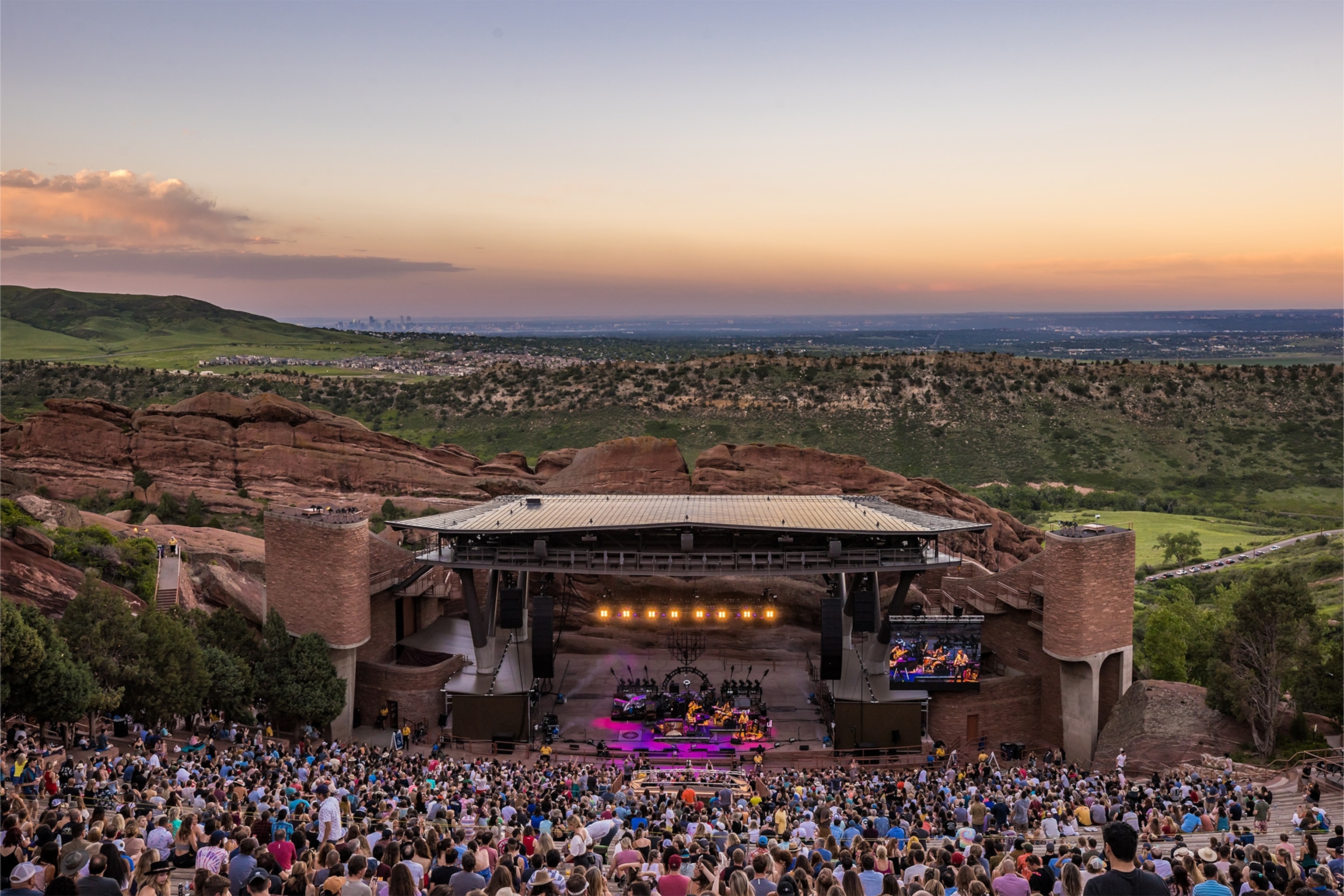 Panoramic view of Red Rocks stage with performance and audience watching