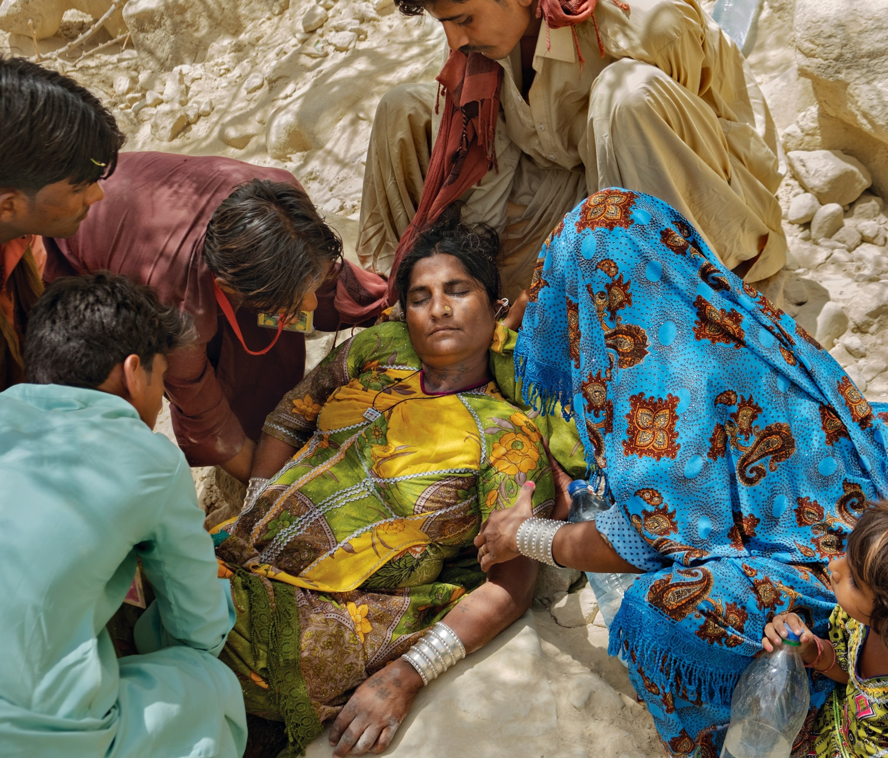 A woman faints from the heat during the Hinglaj, a Hindu pilgrimage.