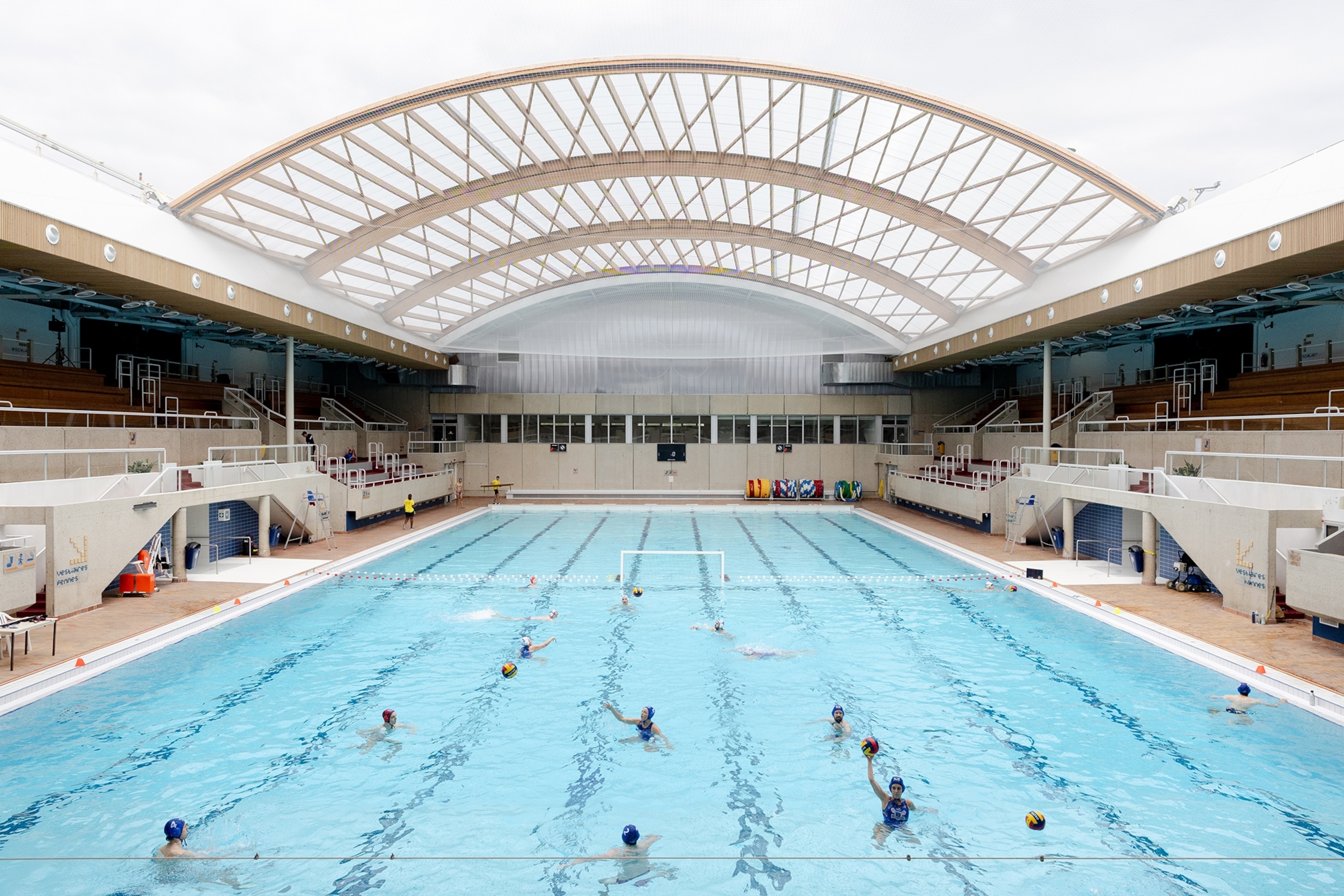 Athletes play water polo at the century-old, recently renovated Georges Vallerey pool, the first in the world to be built specifically for Olympic events.