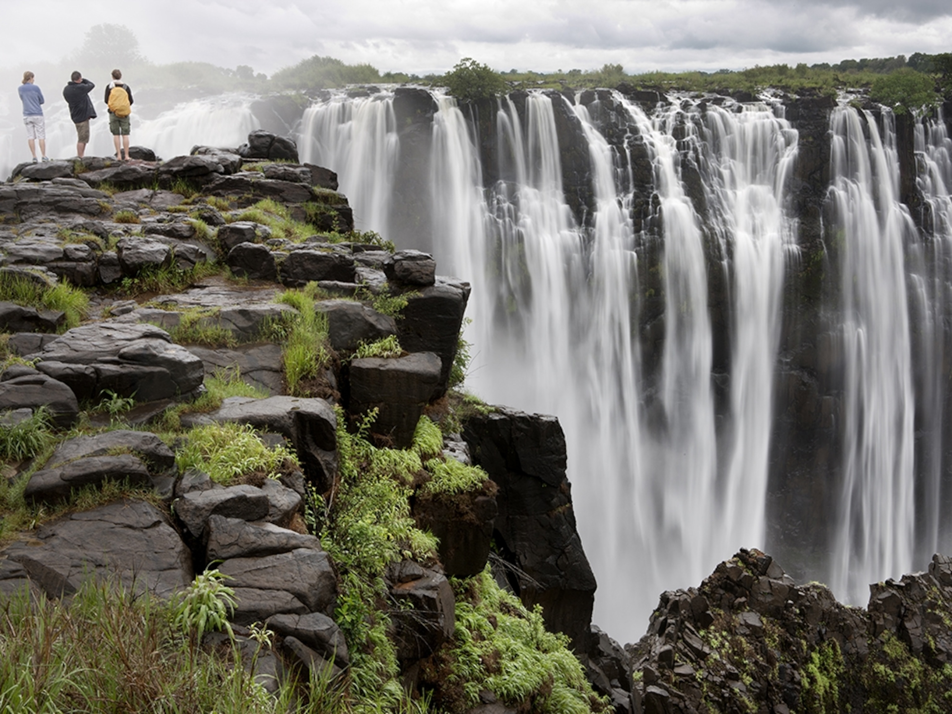 hikers looking out onto Victoria Falls