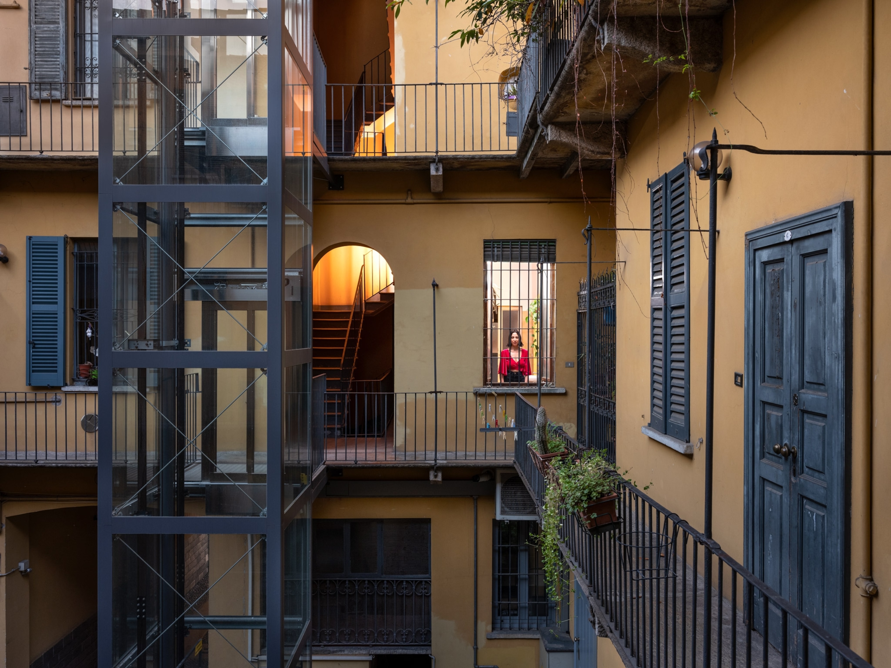 a woman in her home seen through window outside