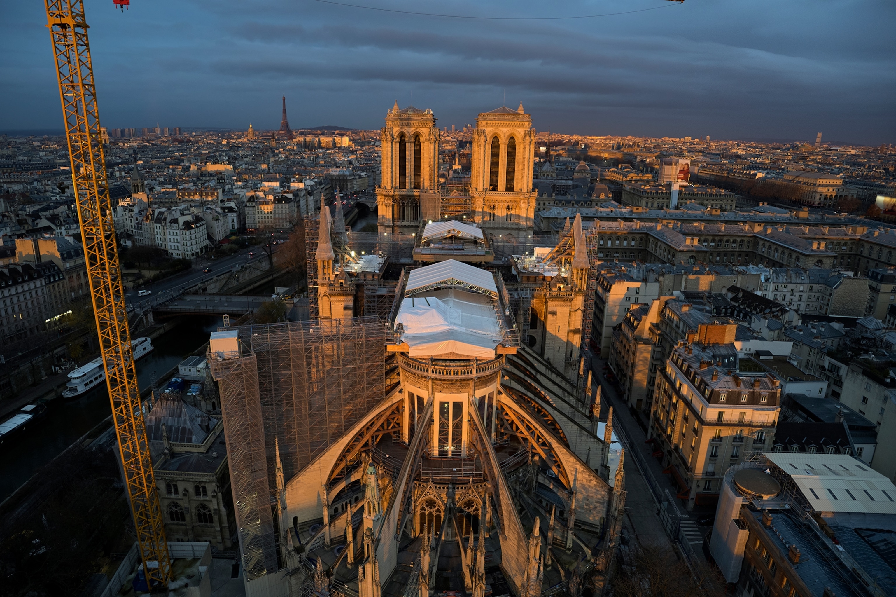 Scaffolding and white tarps adorn the Notre-Dame for restoration after the 2019 fire.