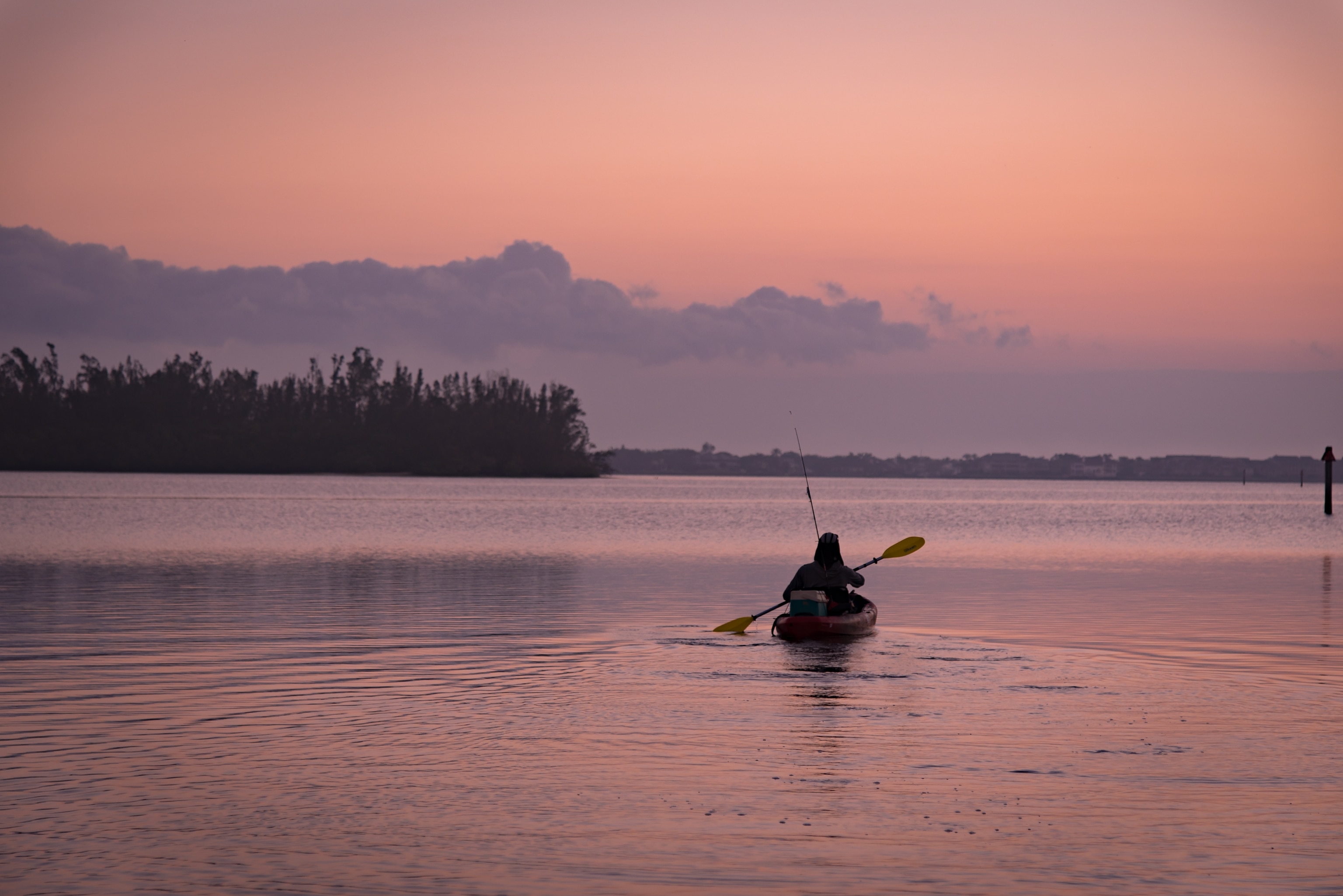 A person kayaks at sunset in Indian River Lagoon