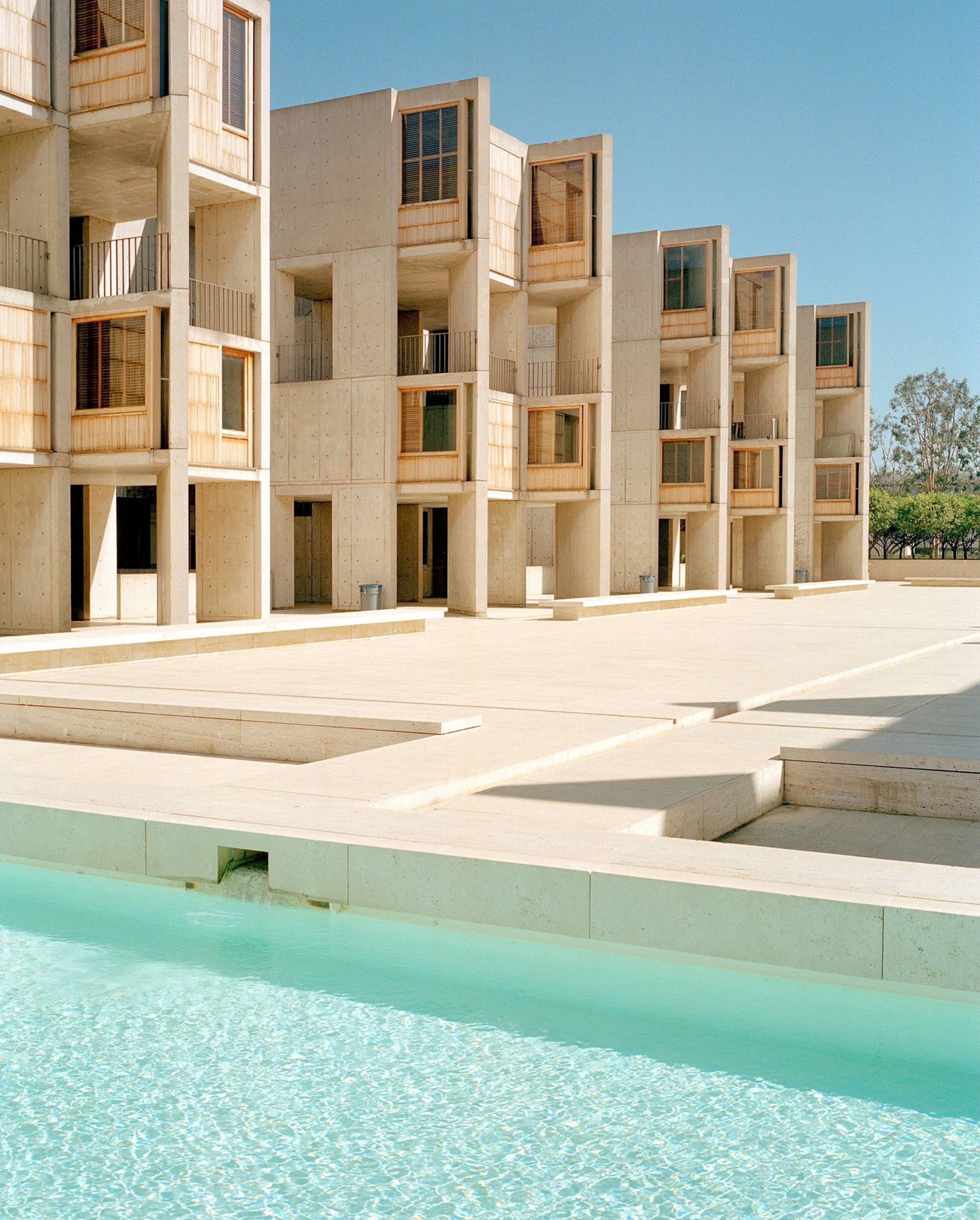 A blue pond and the concrete Salk Institute for Biological Studies in San Diego.