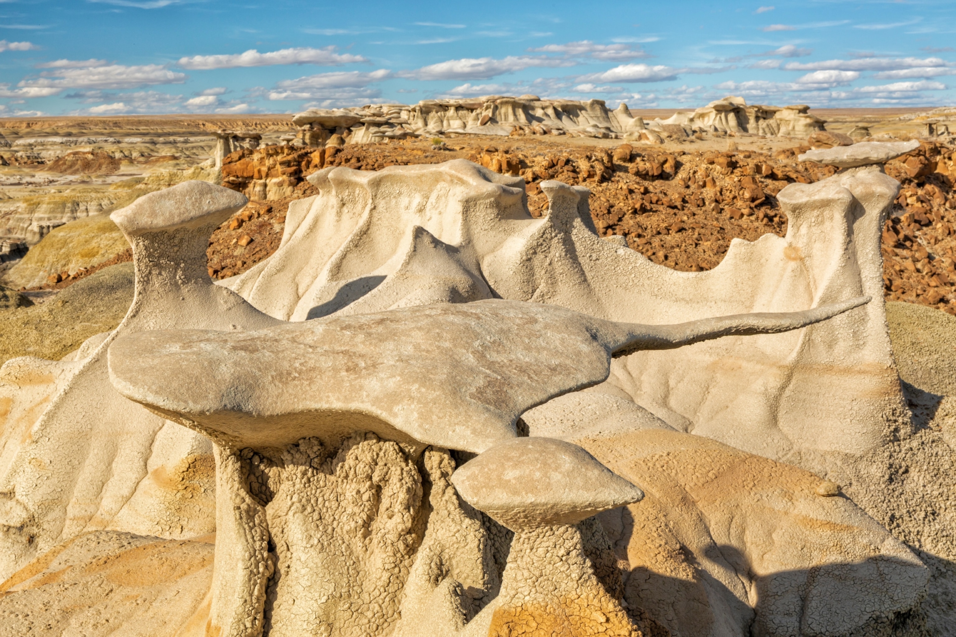 A thin slice of rock sits delicately upon its thin rock base