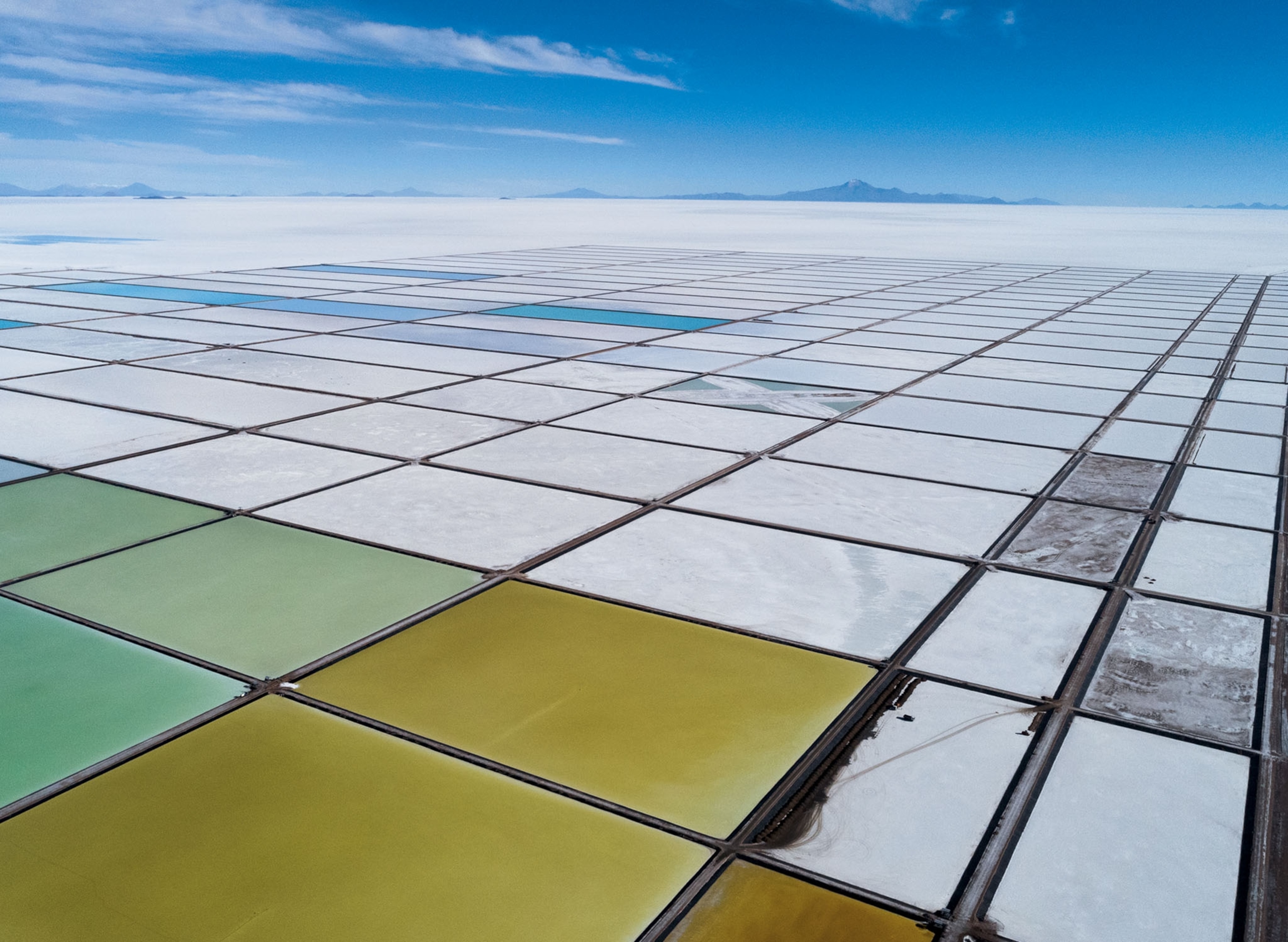 an aerial view of large green, blue, yellow, and white pools