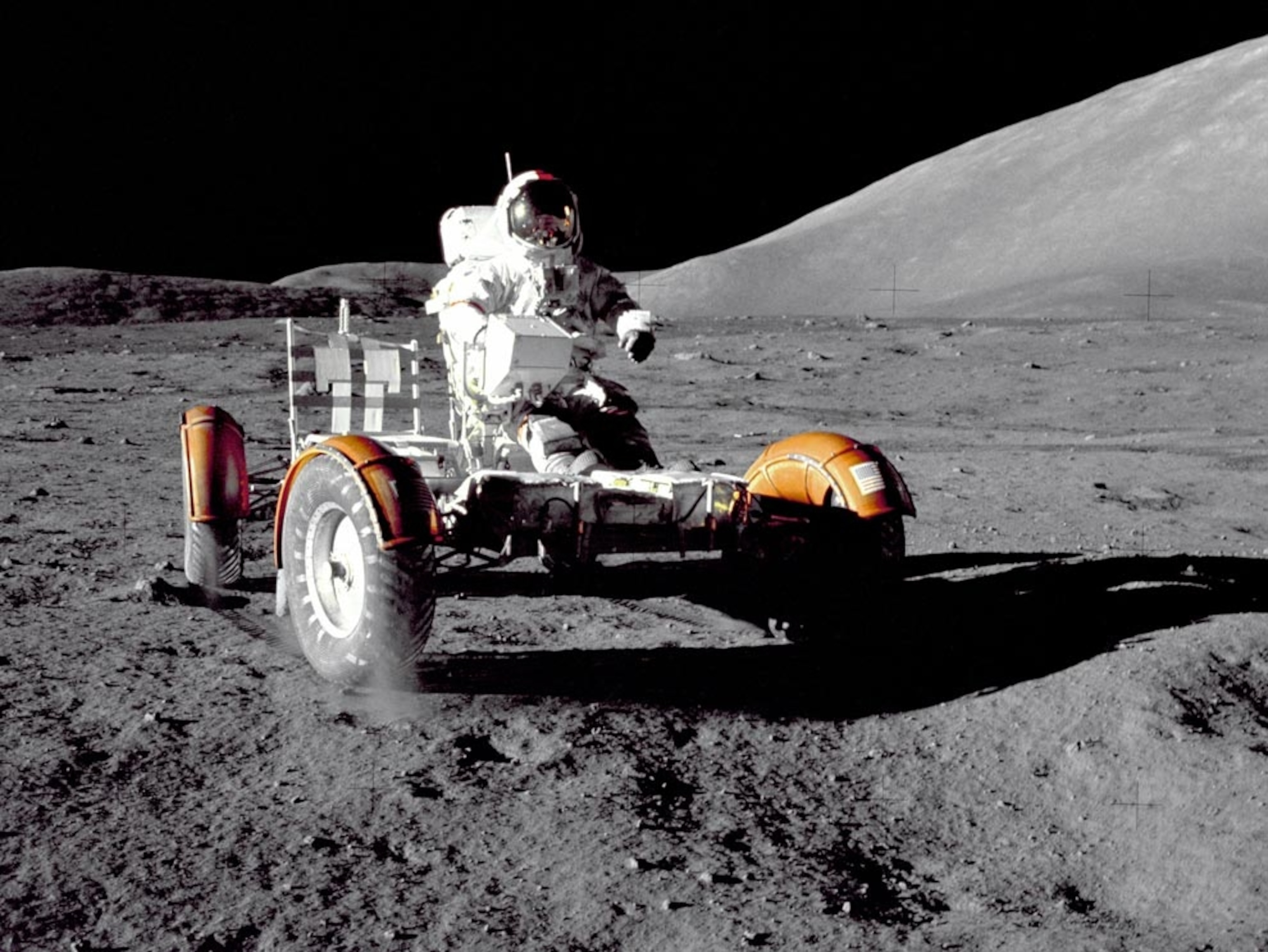 an astronaut in moon buggy