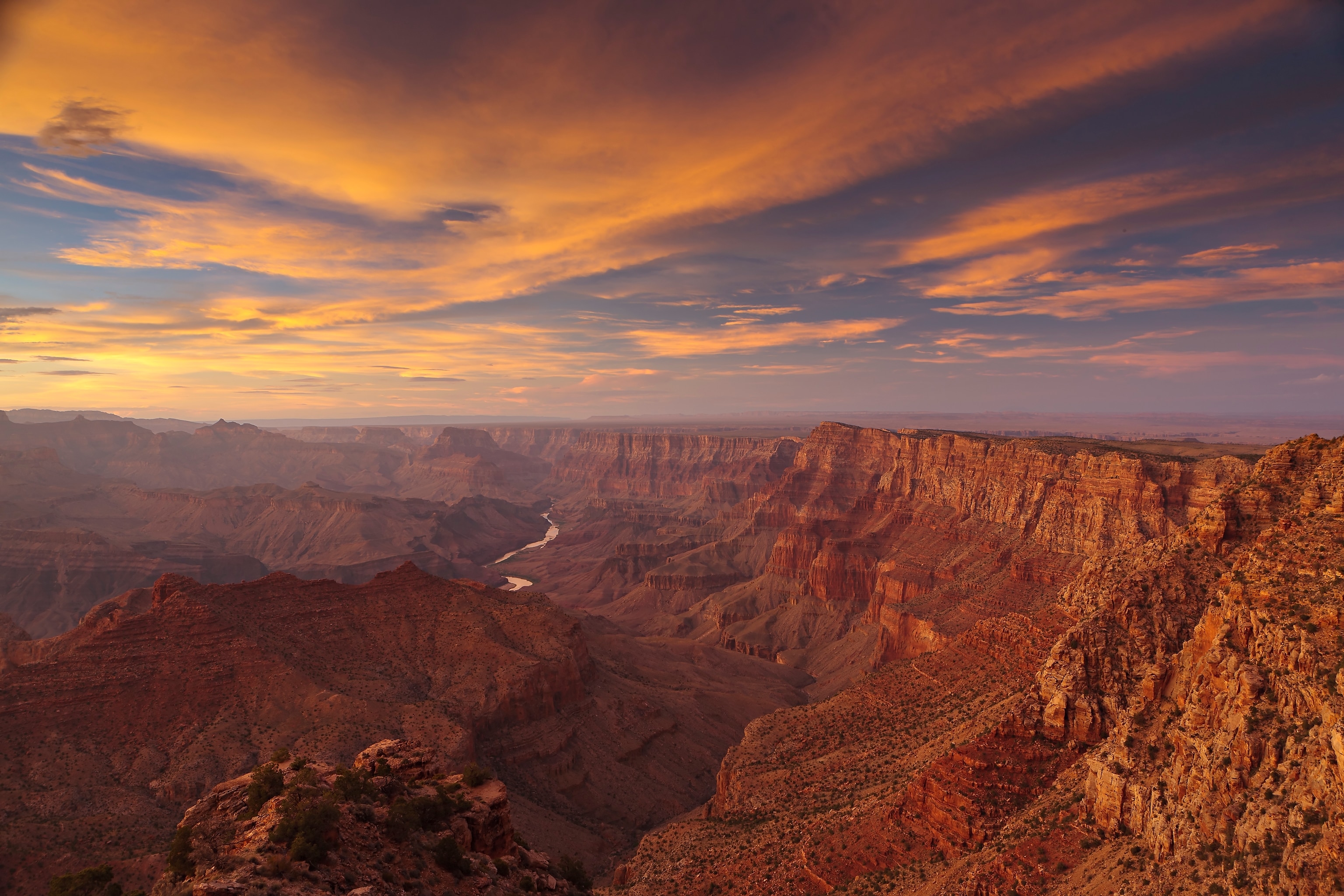 Sunset afterglow illuminates canyon cliffs at Navajo Point.