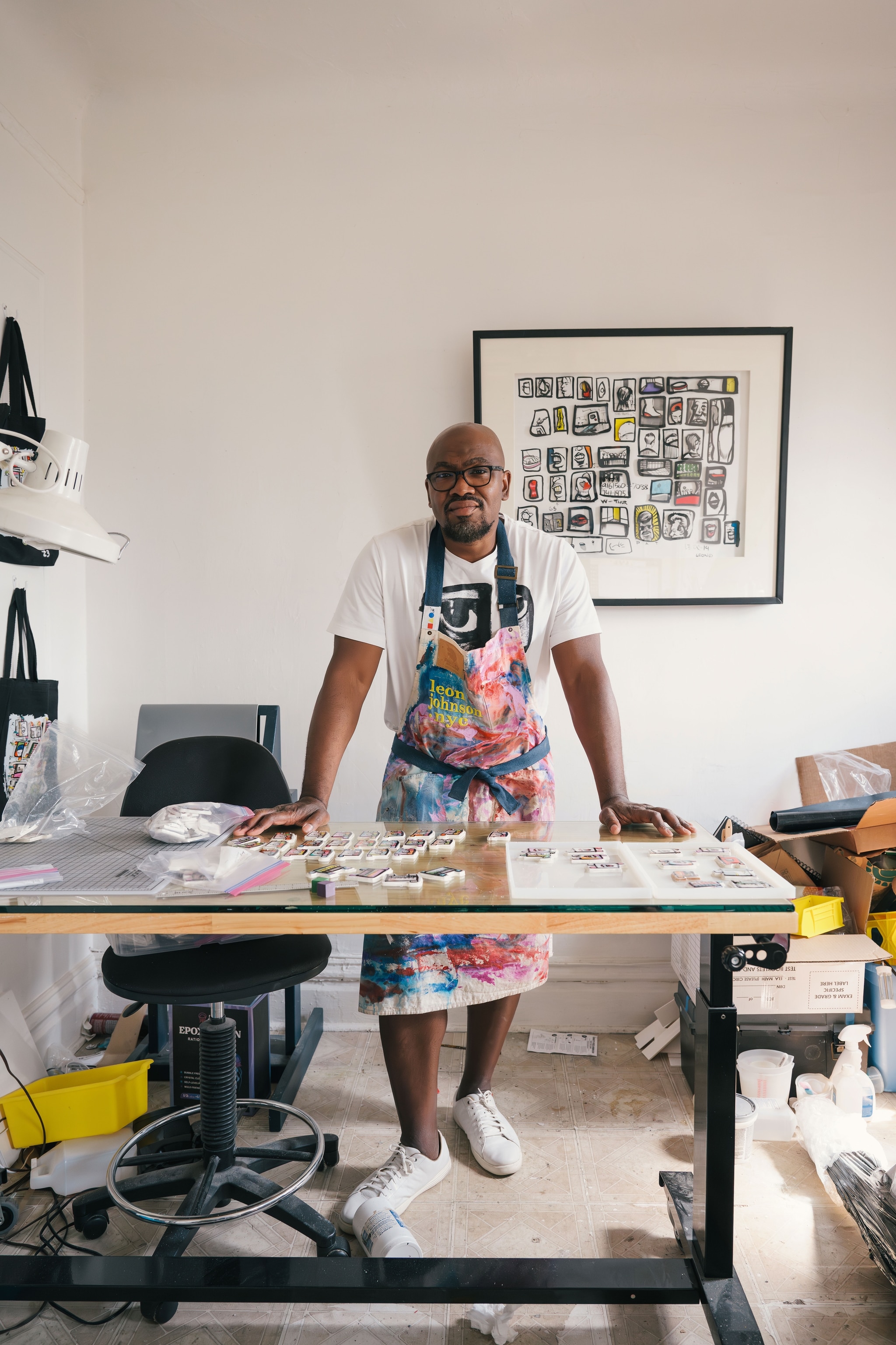 man standing within his studio with an apron on
