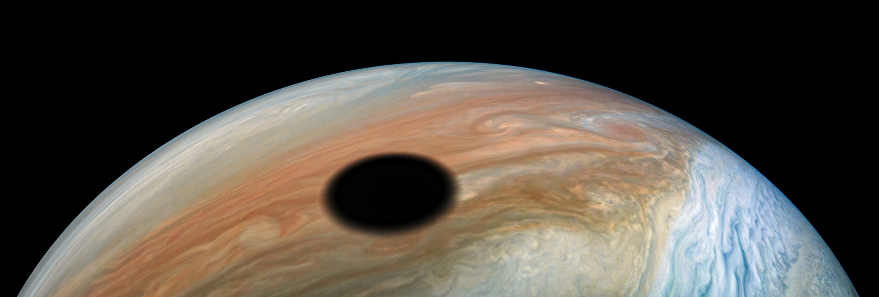 Jupiter's volcanically active moon Io casts its shadow