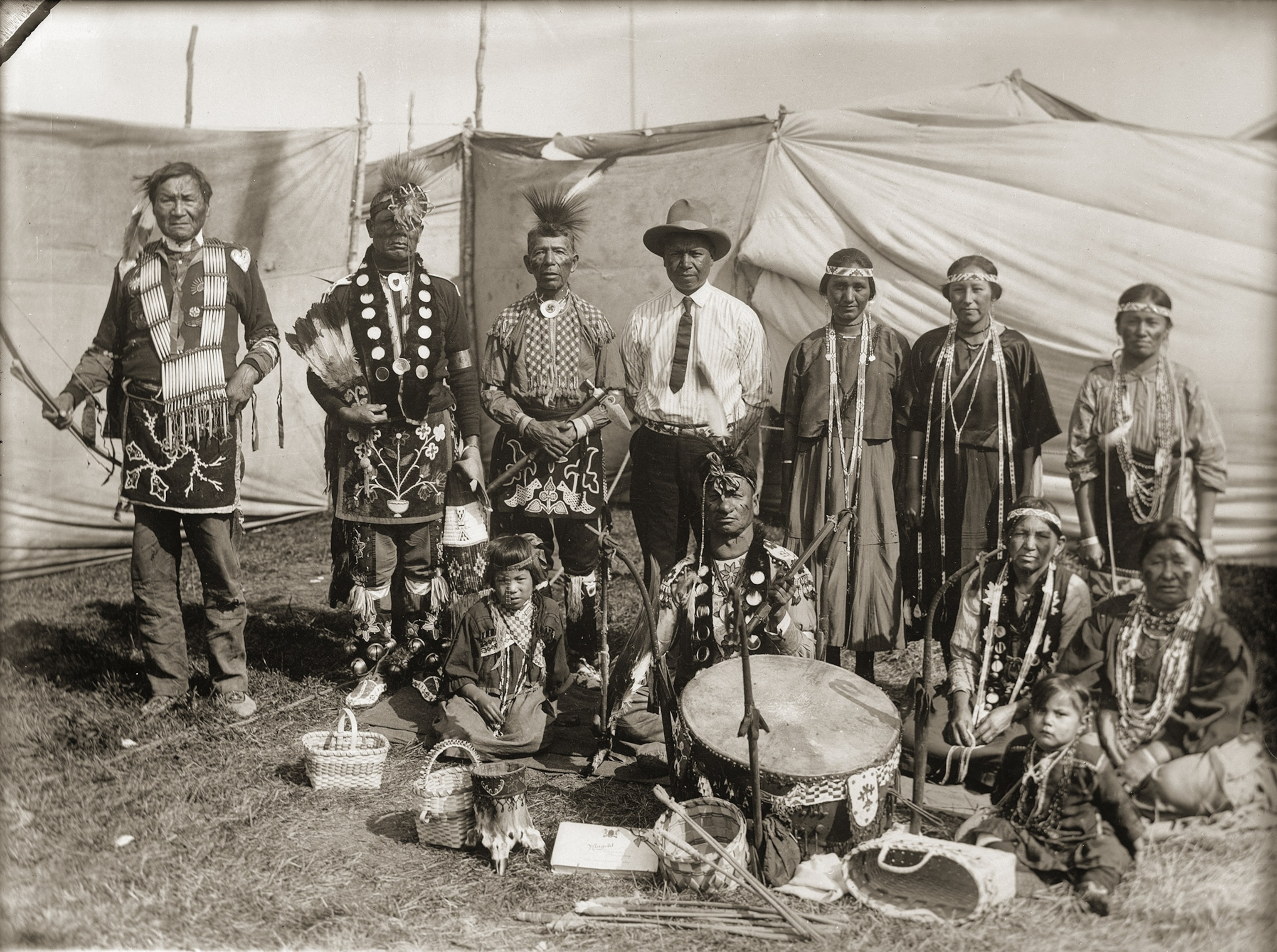A group of people stand togehter dressed up with instruments center frame for a photo.