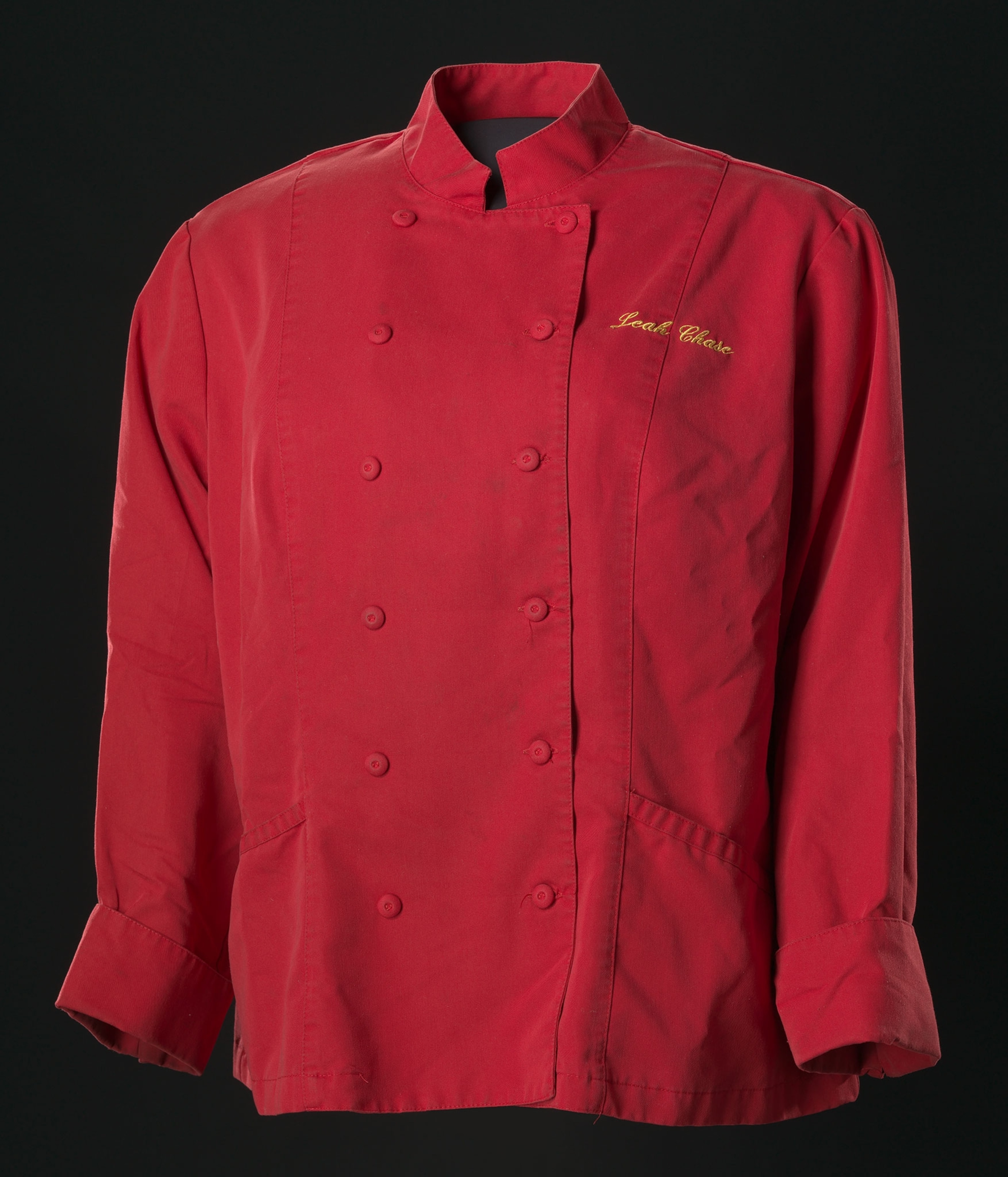 A red chef's coat against a black background