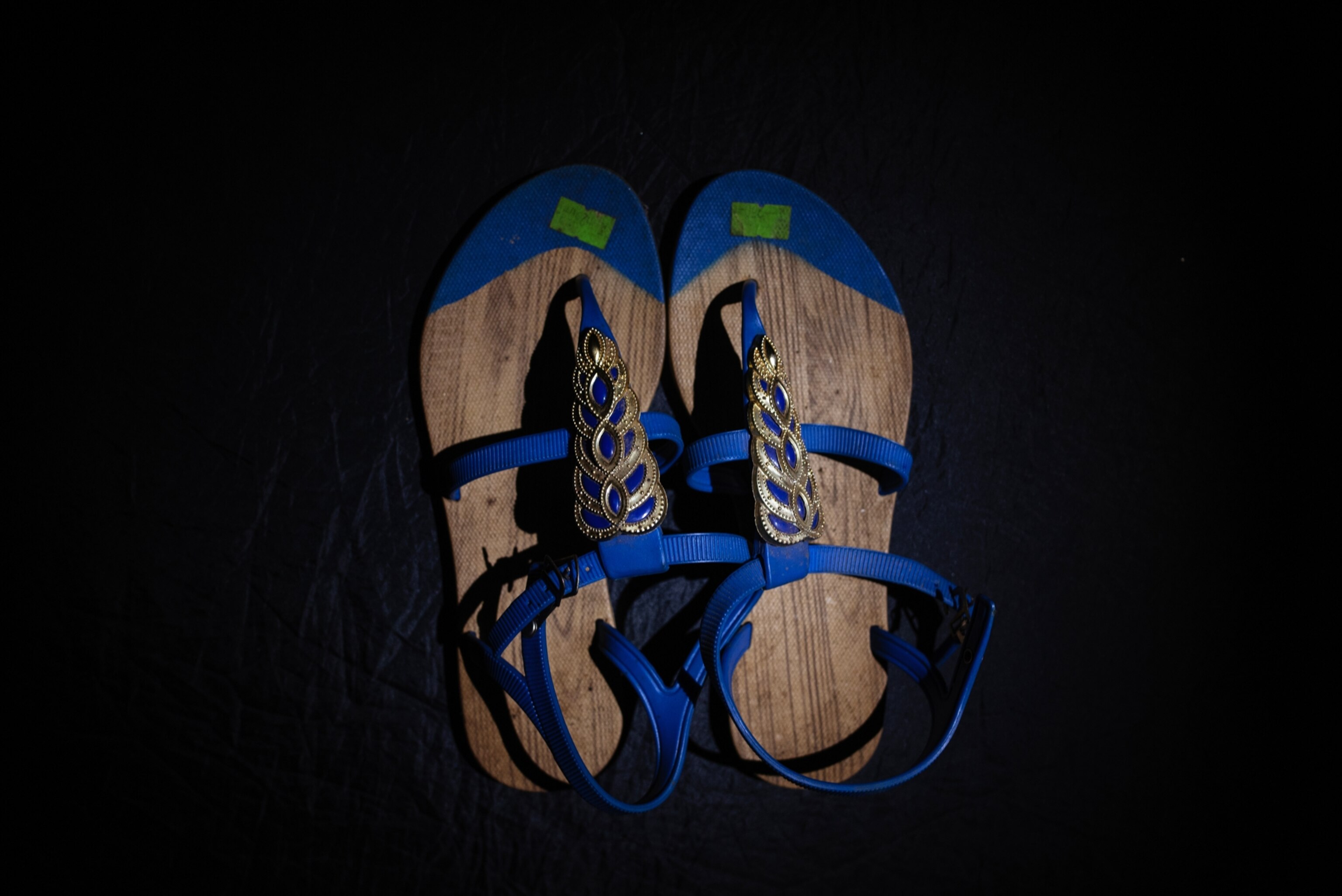 a pair of sandals with blue straps