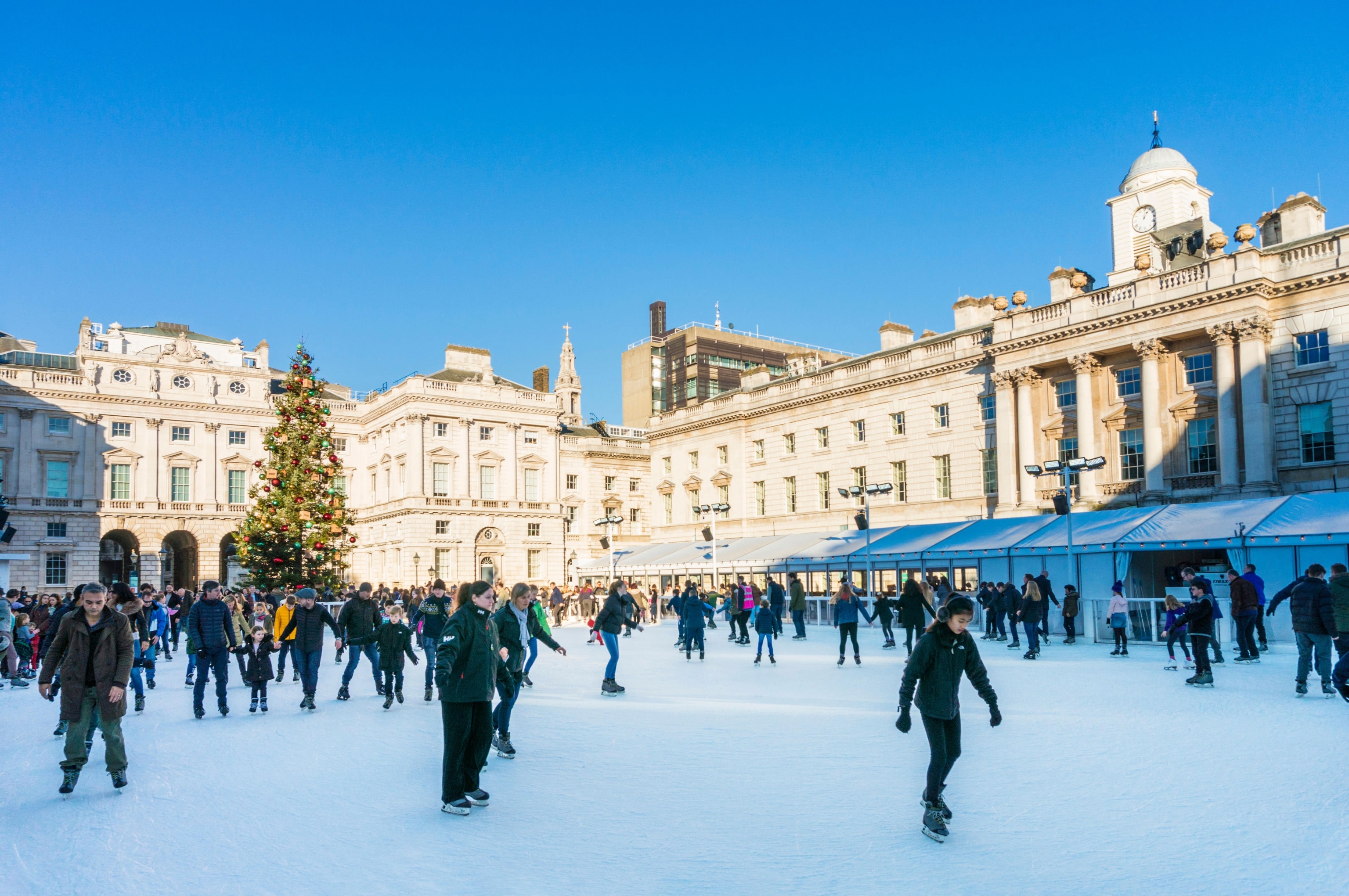 people skating on ice on clear day