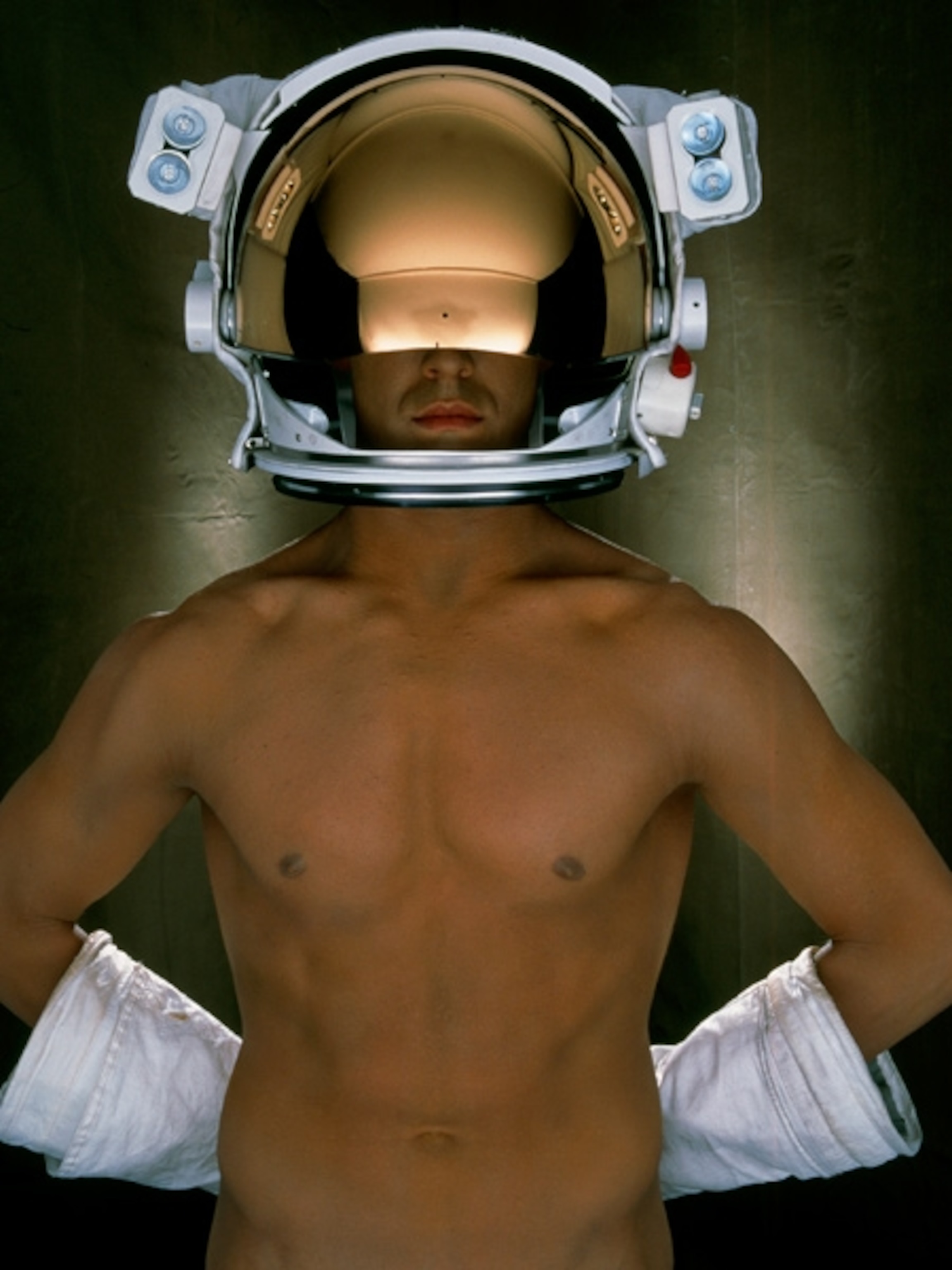 a man wearing astronaut helmet and gloves