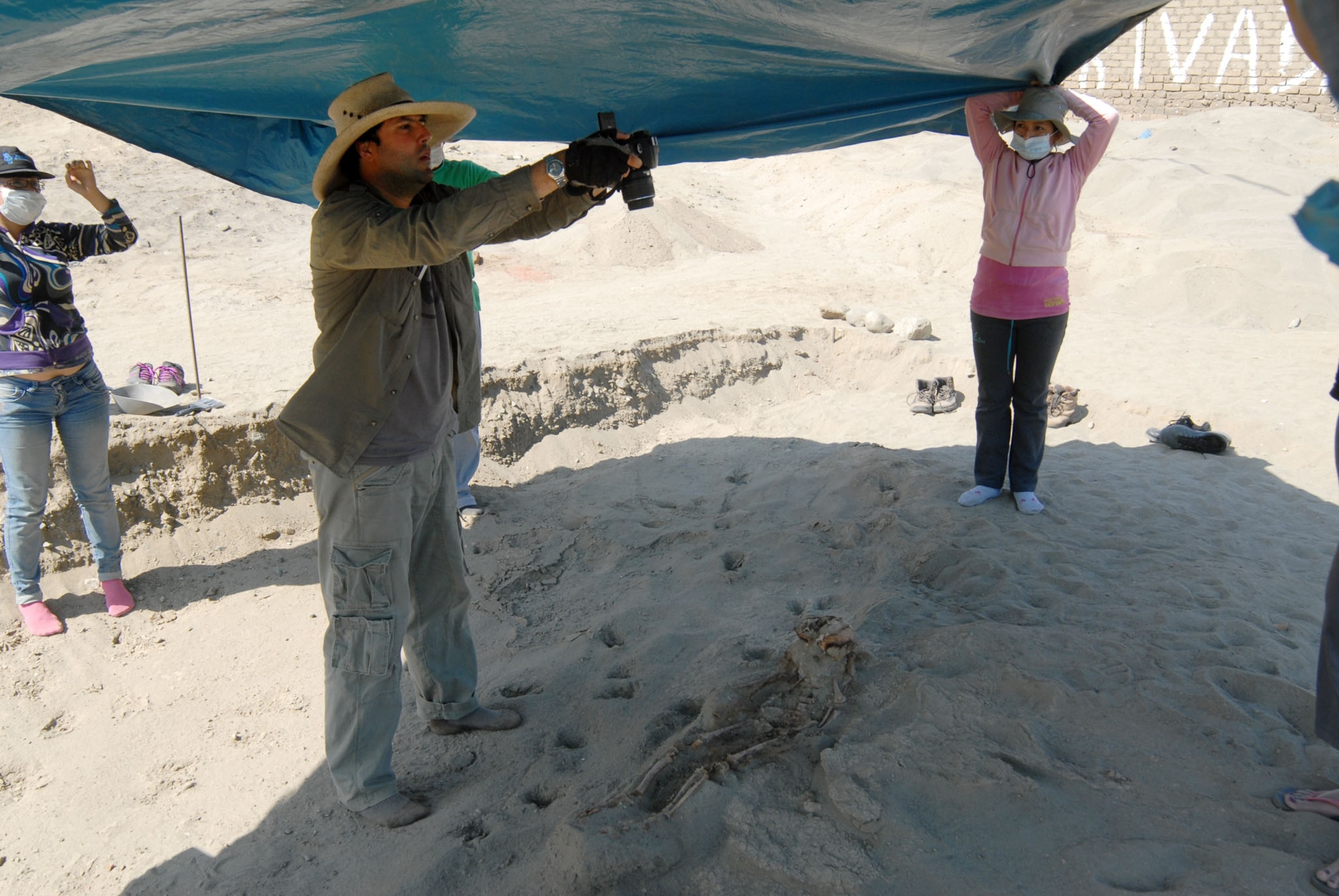 scientist taking picture of human remains.