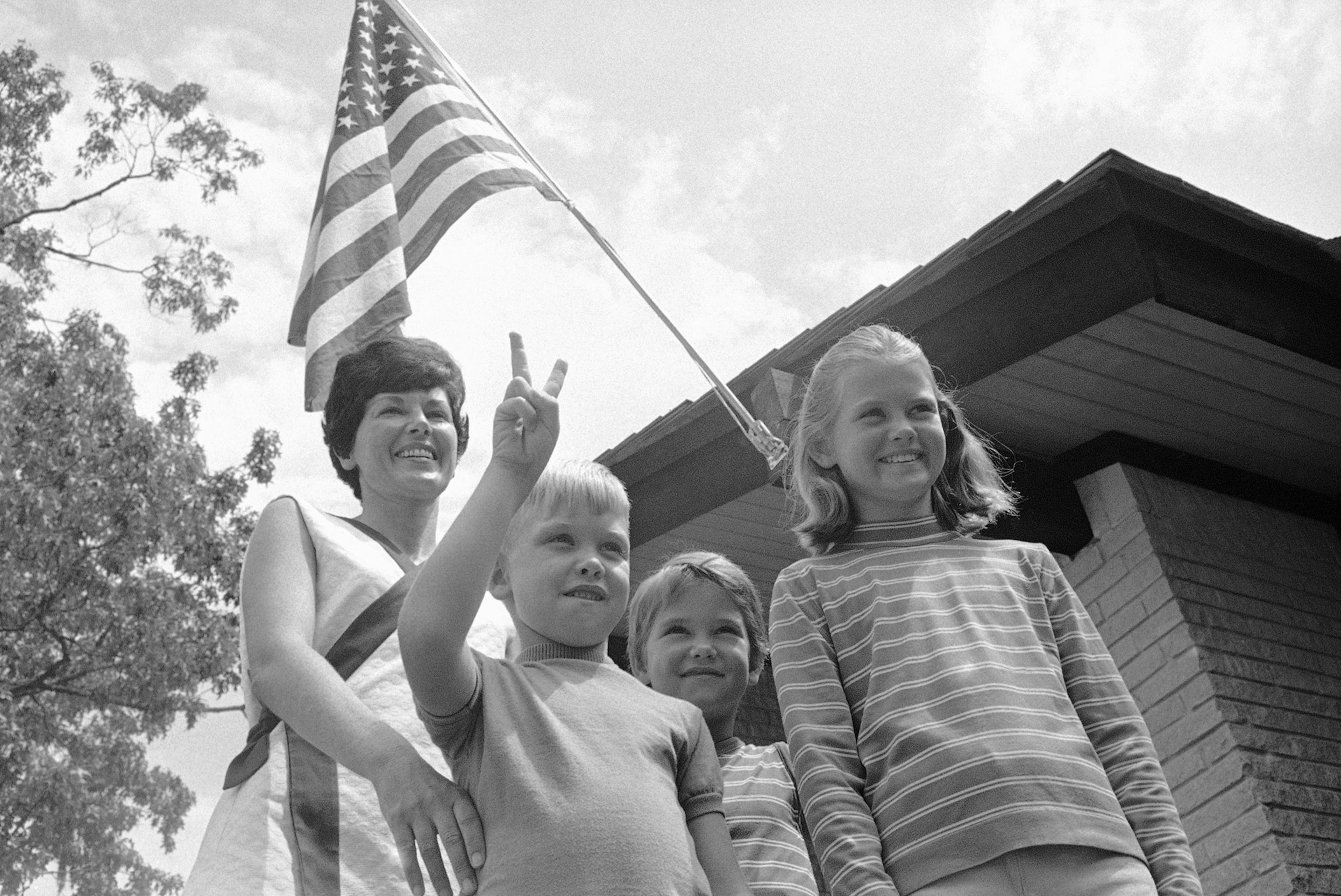 a family in front of an American flag