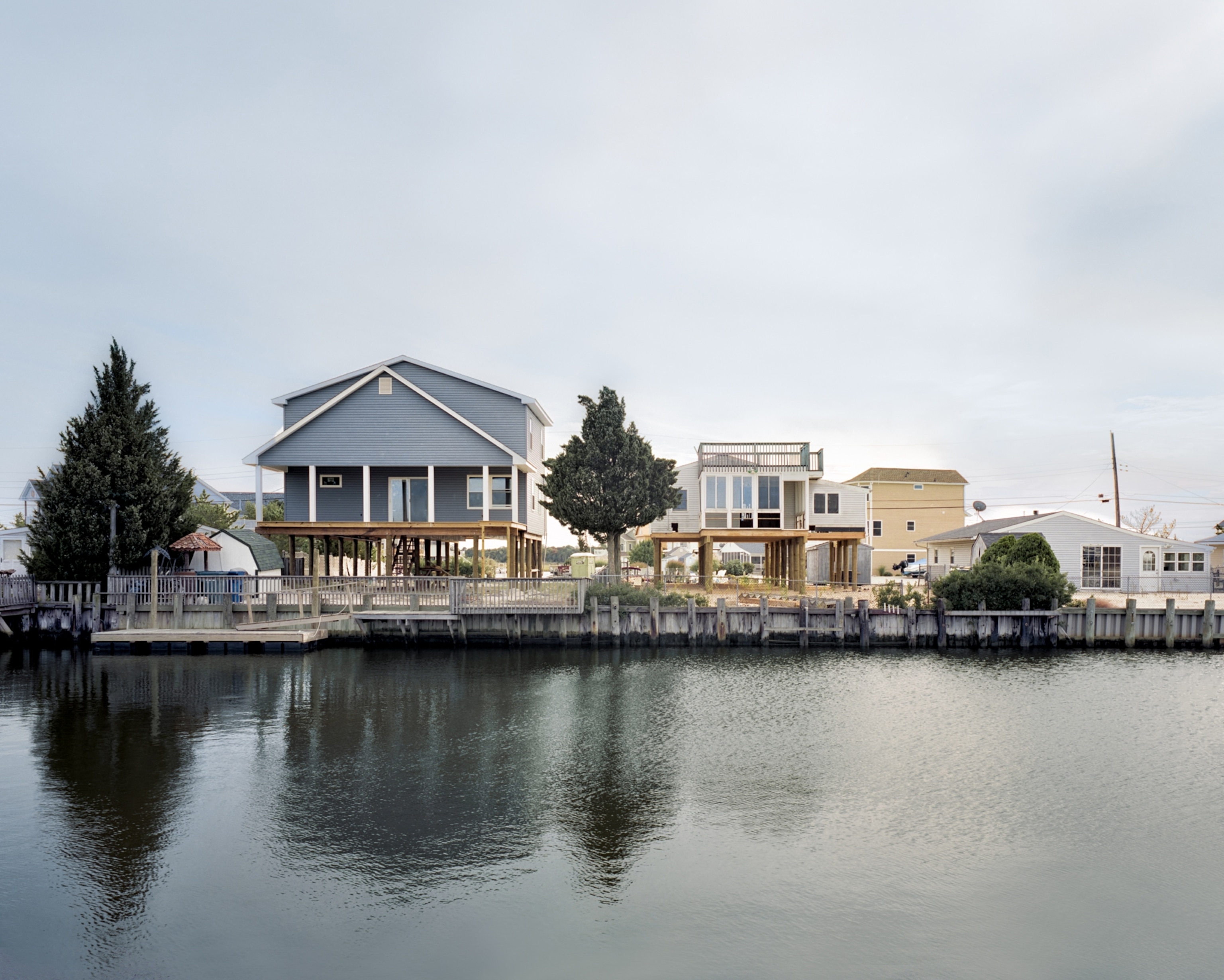a light blue house on a lagoon