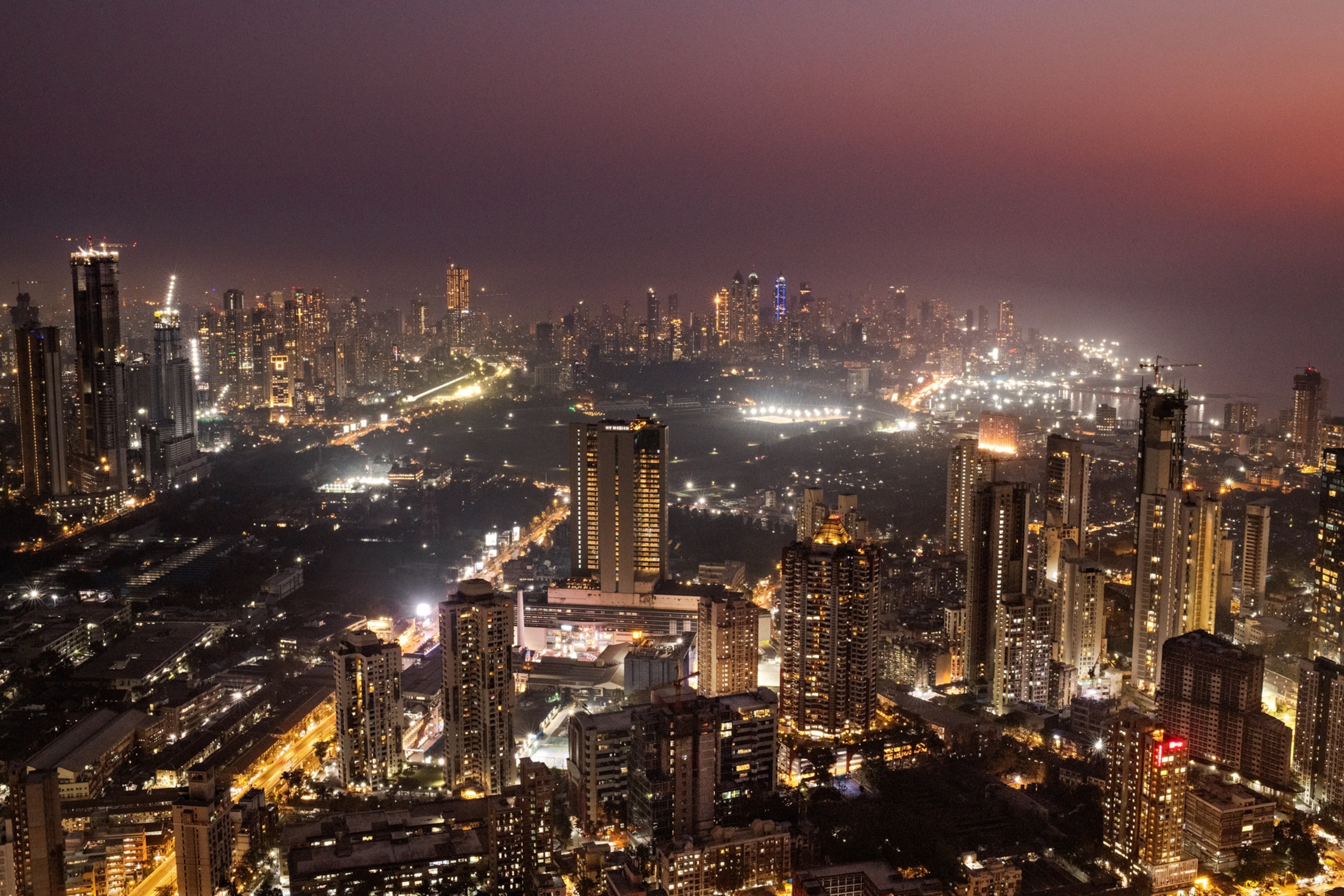 Picture of aerial view of well-lit city at night.