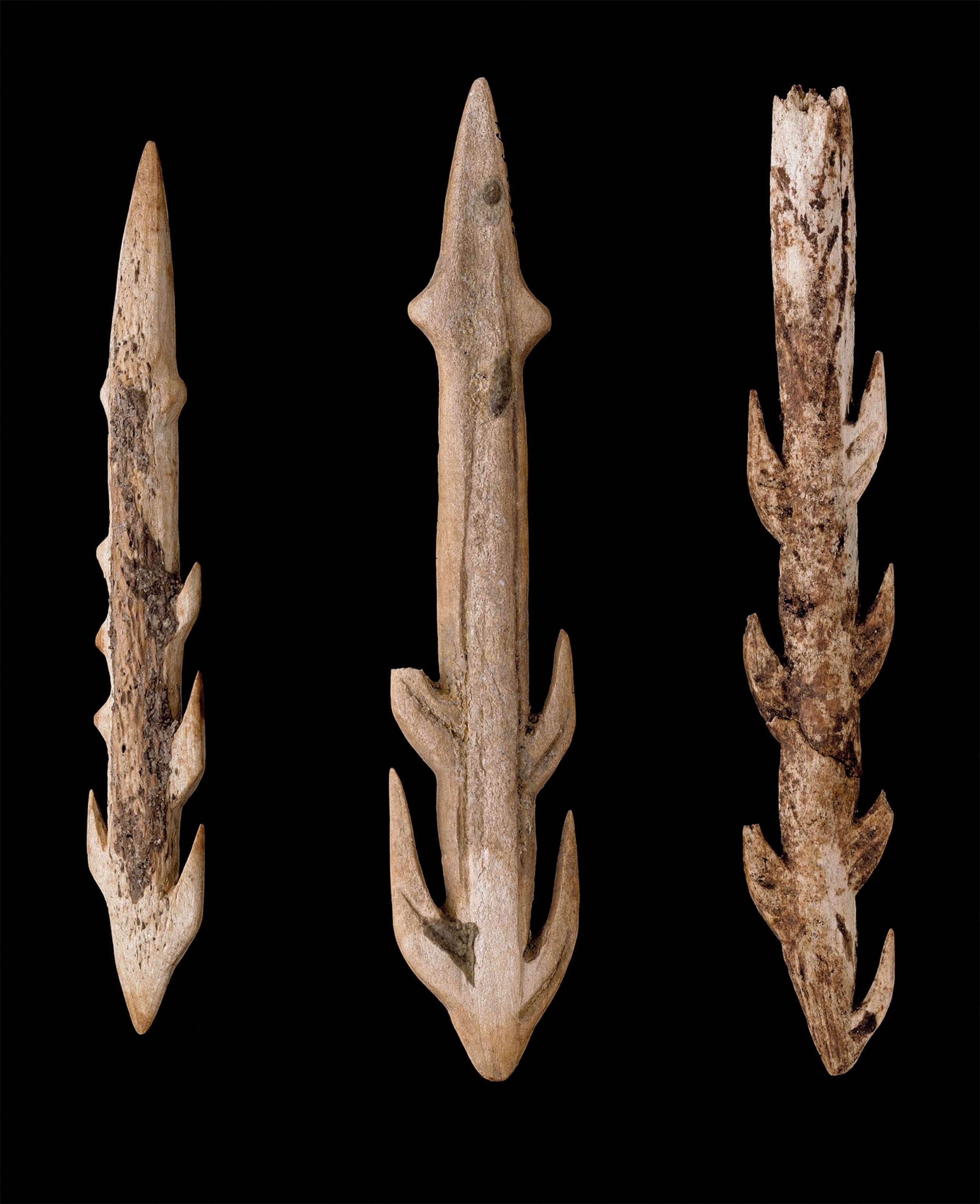 3 bone and antler tools set against a black background