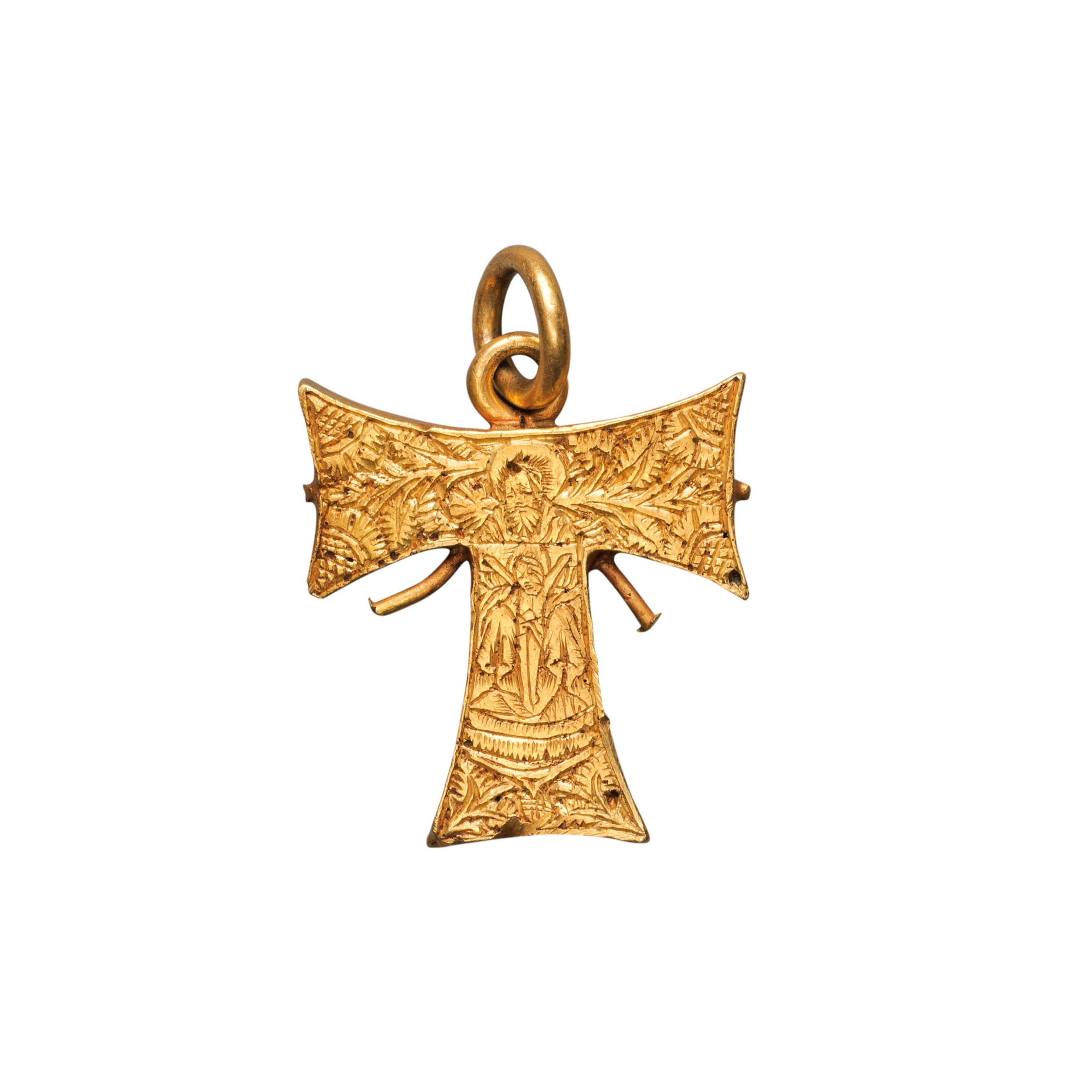 a gold medicine capsule in the form of a St. Anthony's (or Tau) cross