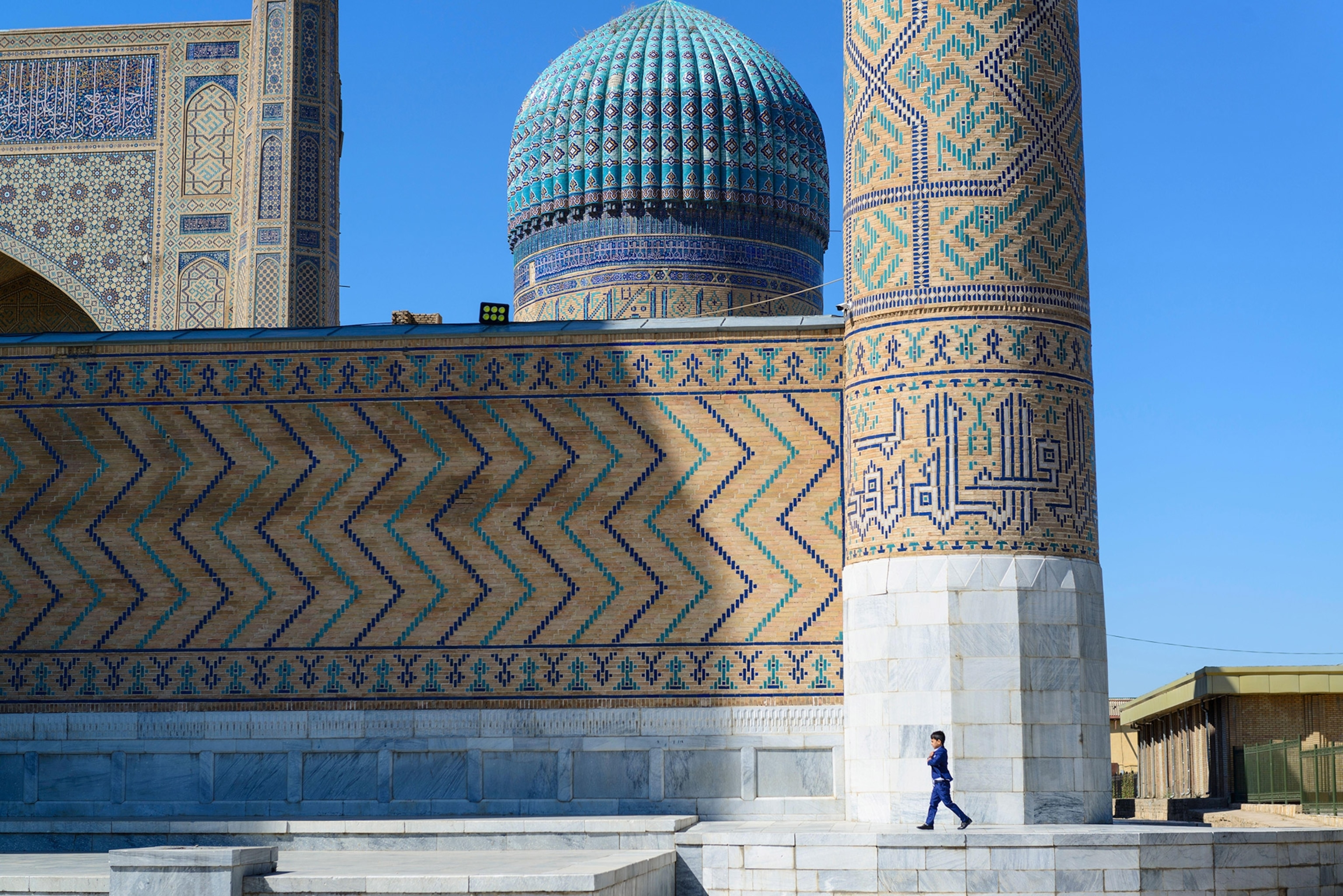 Young boy walking in front of the Bibi-Khanym mosque