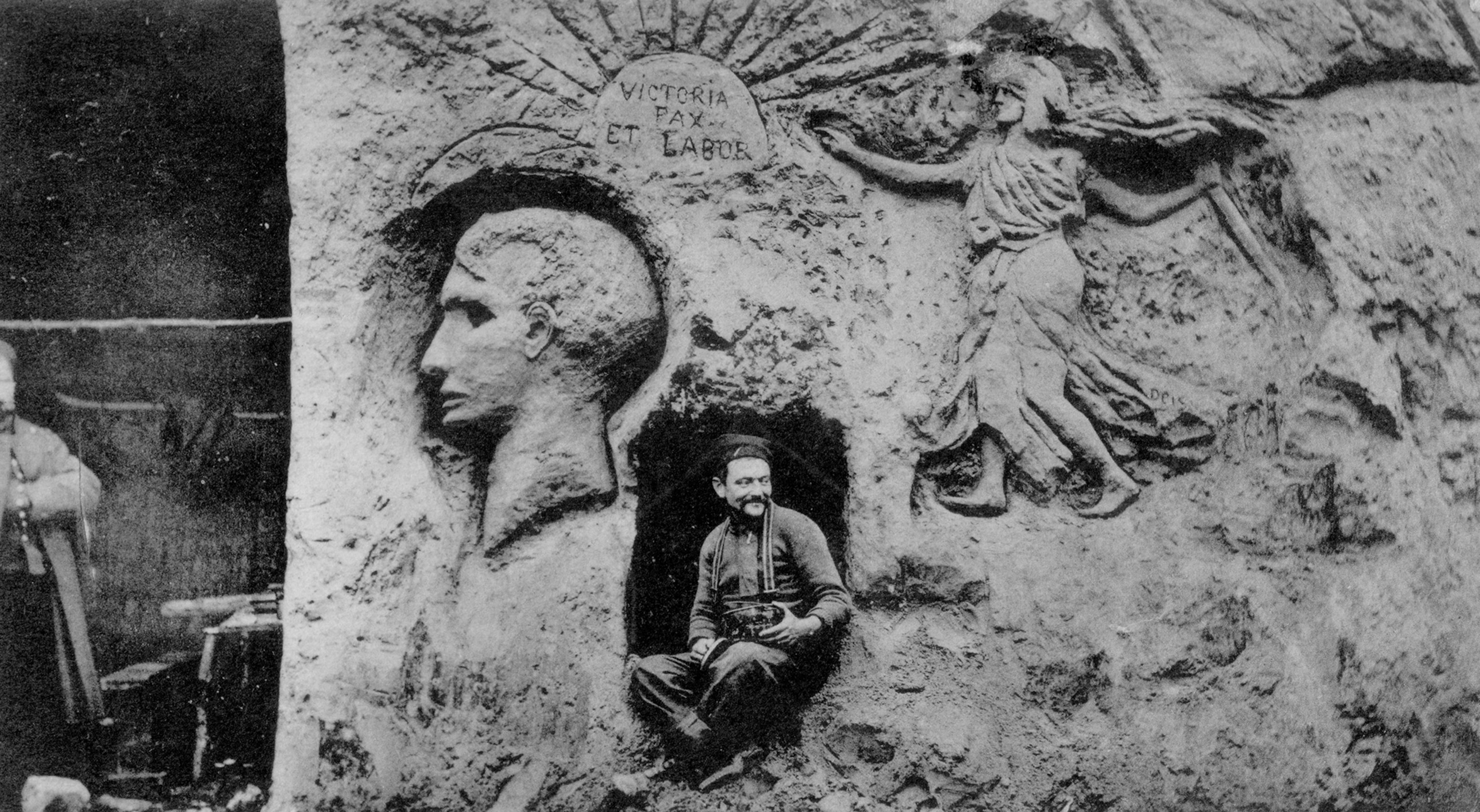 a French soldier sitting among sculptured reliefs of Napoleon and the victorious republic