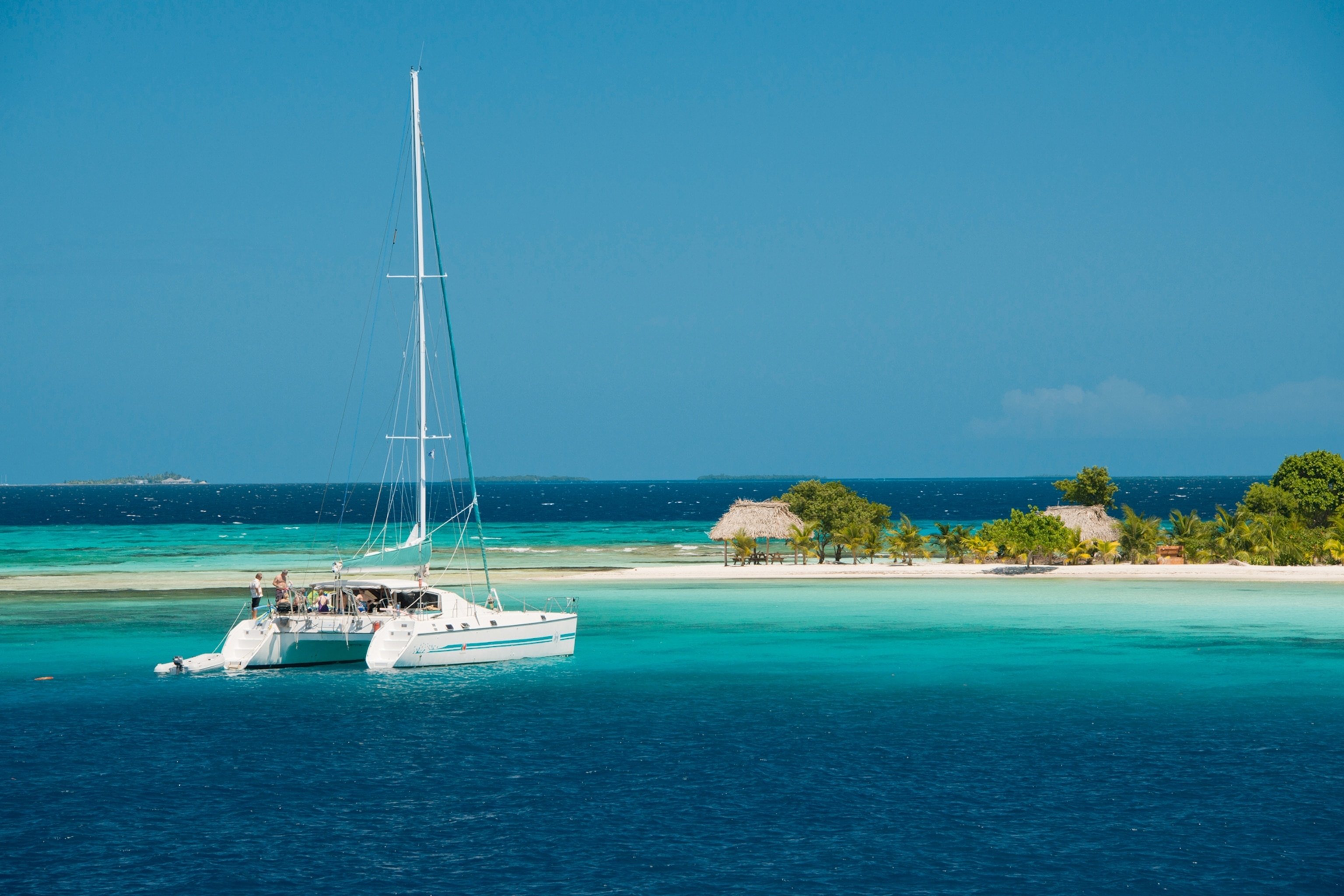 a catamaran floating near an island