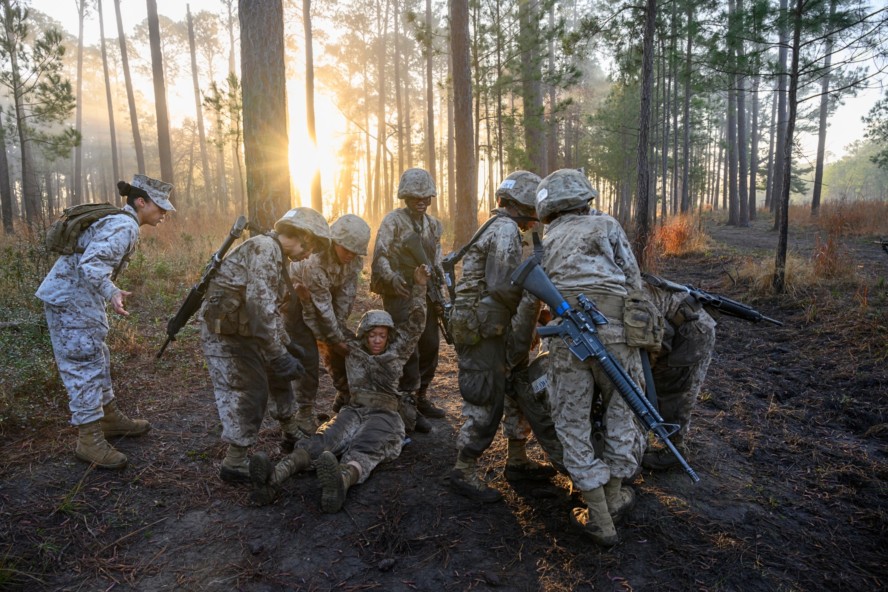a group of woman carrying a pretend woman soldier