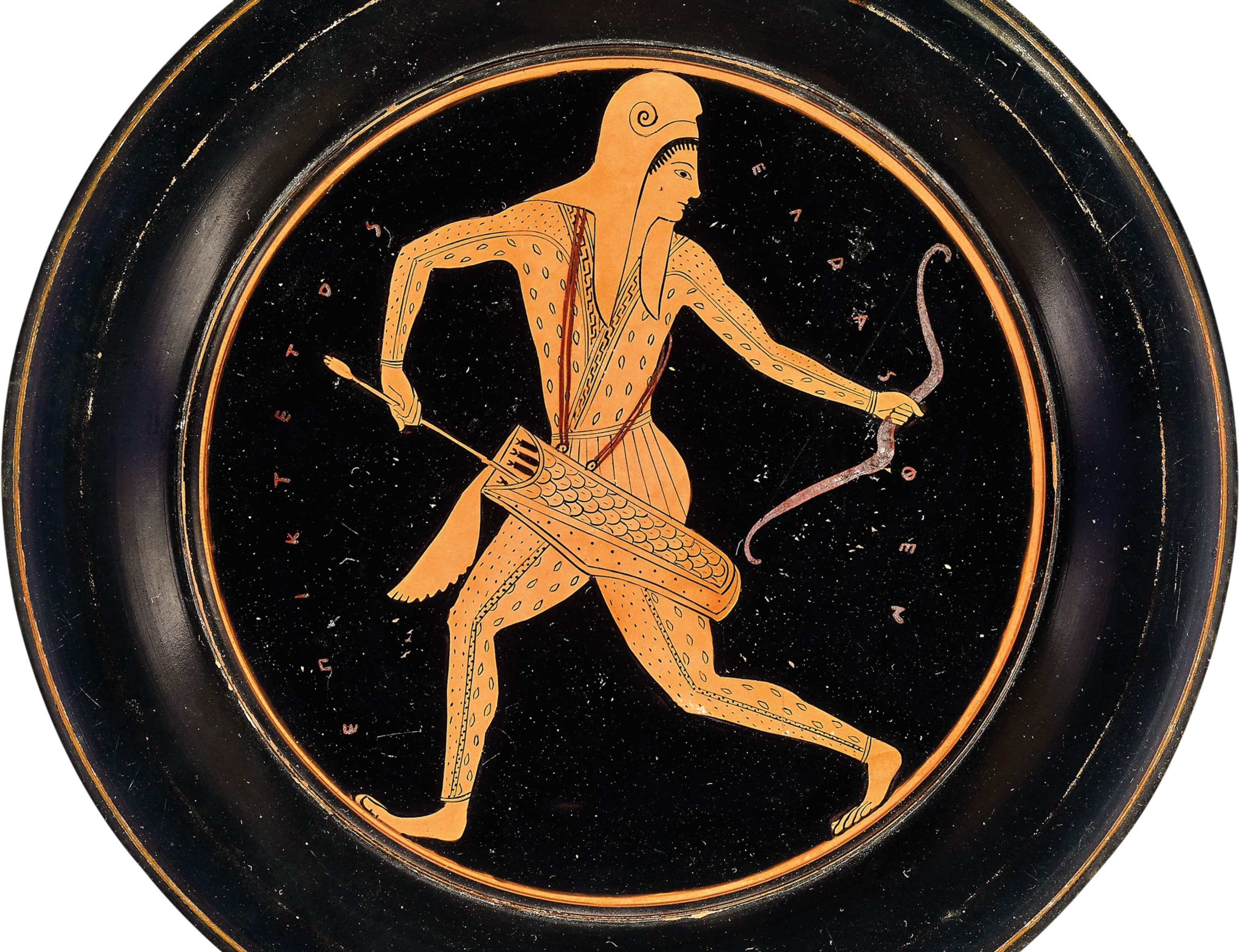 a black plate with a drawing of a woman archer on it