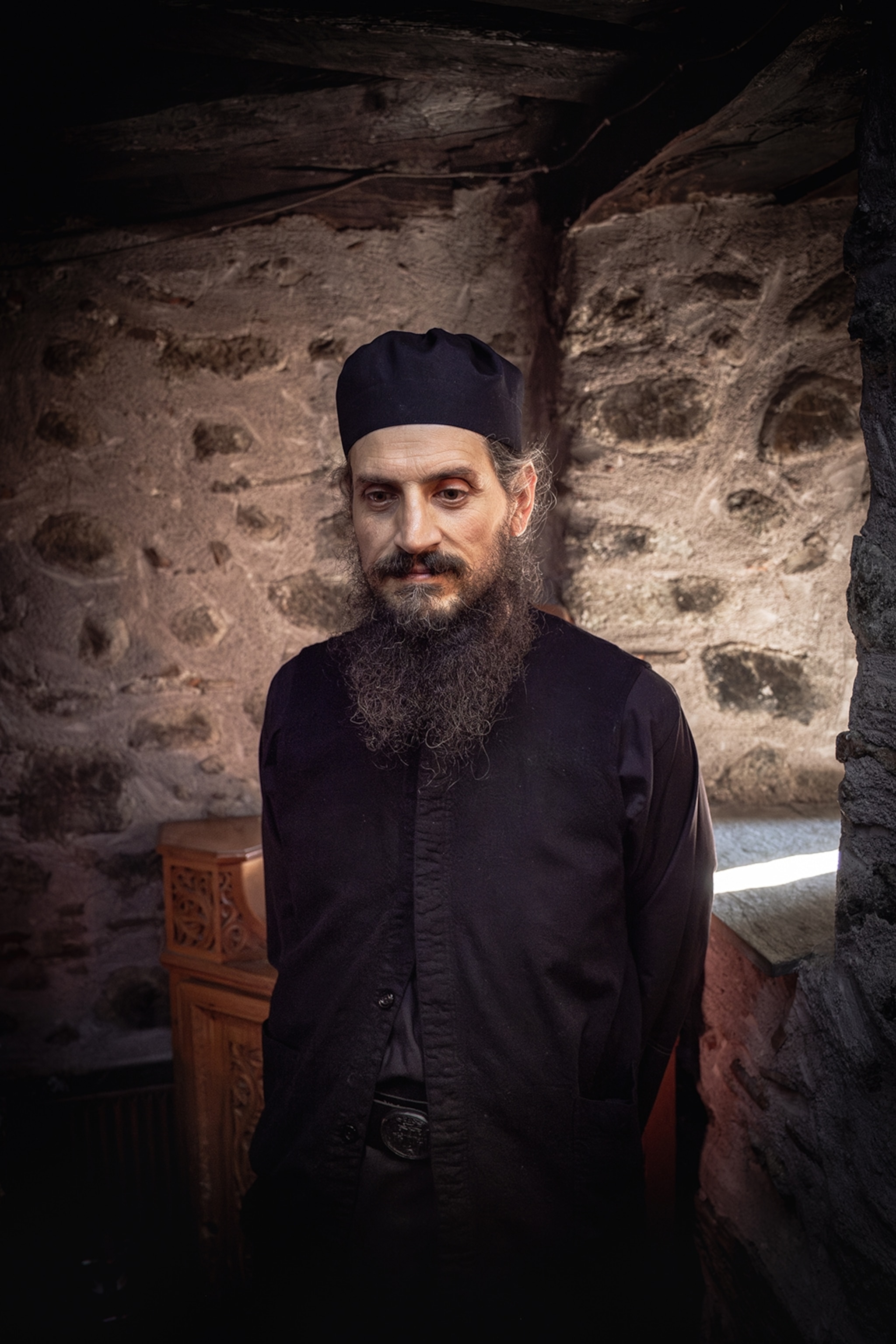 A ghostly and stern monk with a gentle yet absent gaze and long beard in a dramatically lit vault room.