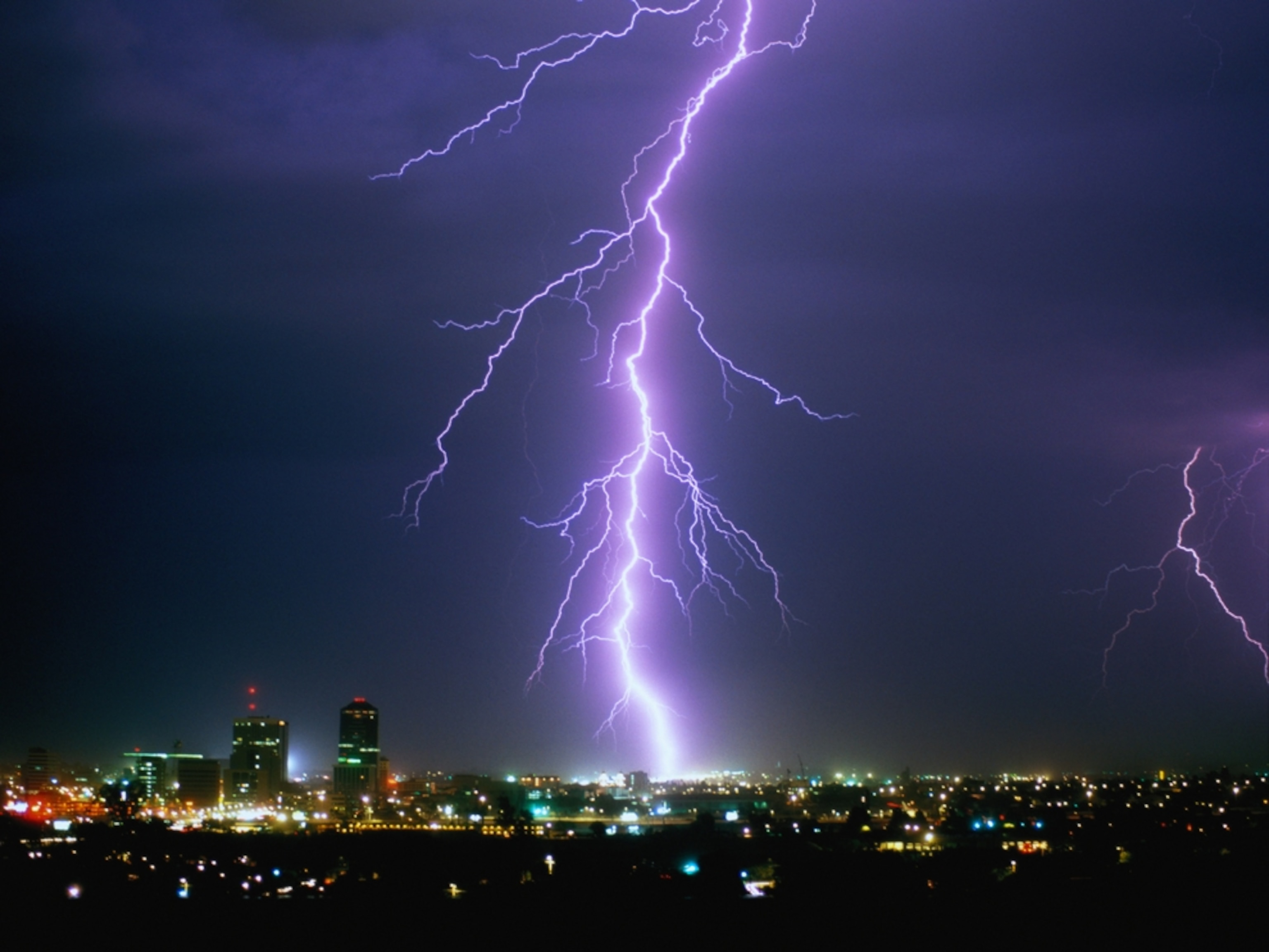 Lightning illuminating a city skyline