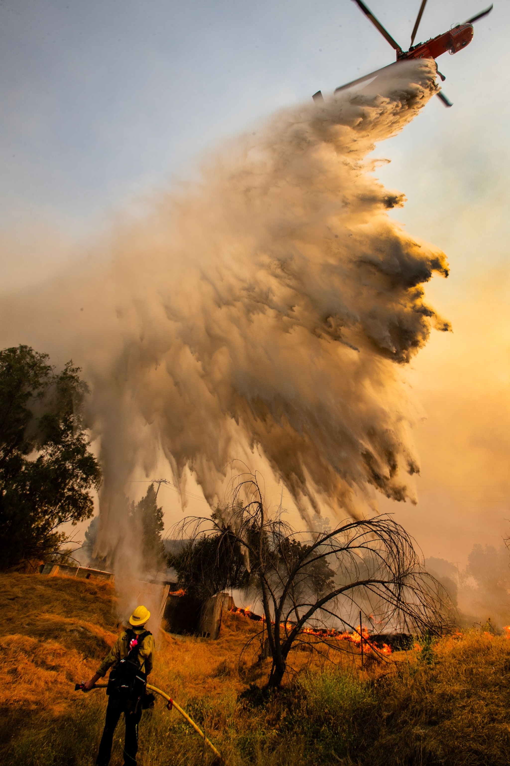 water drops from a helicopter onto a fire