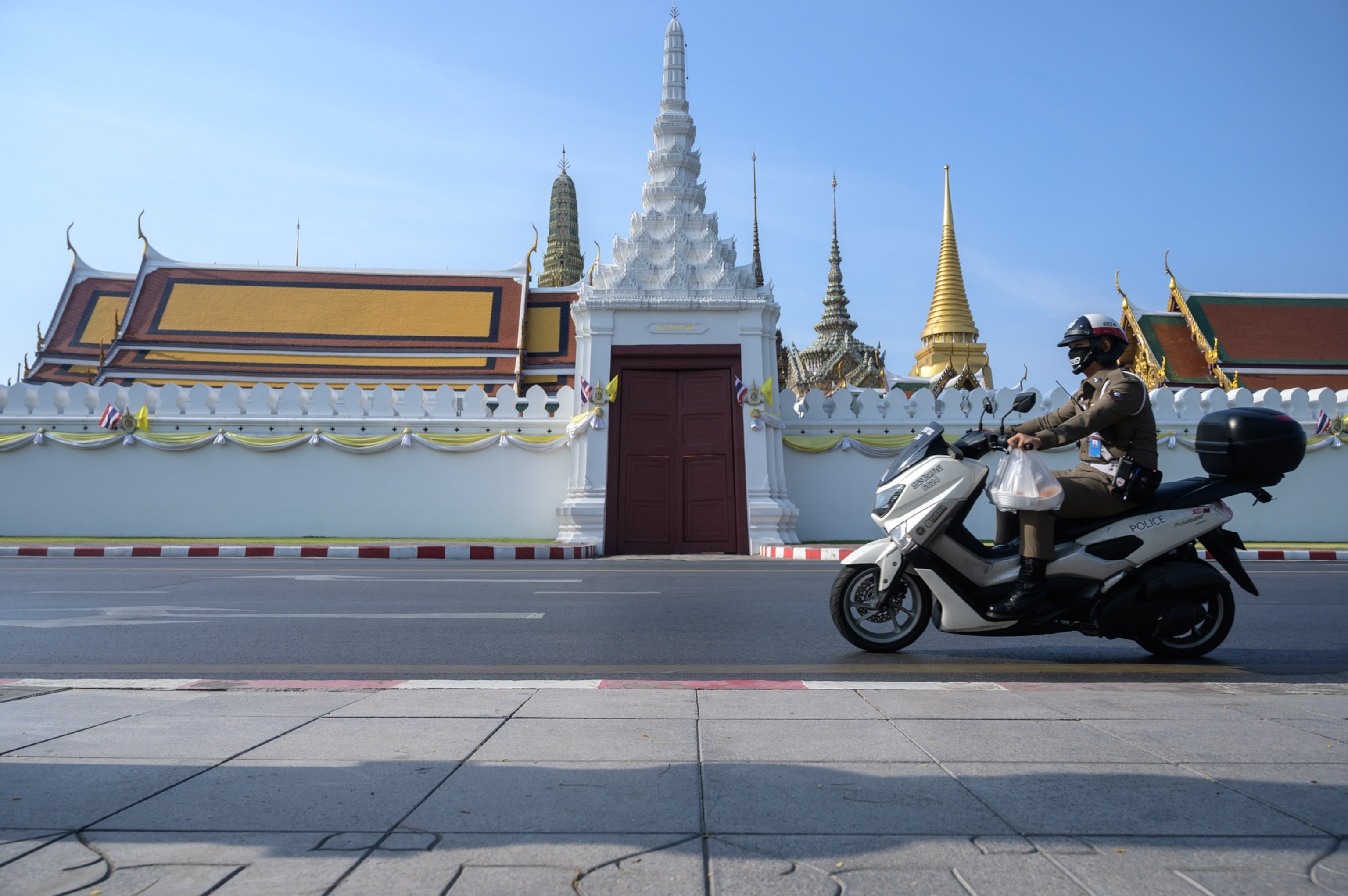 a police officer driving on a scooter